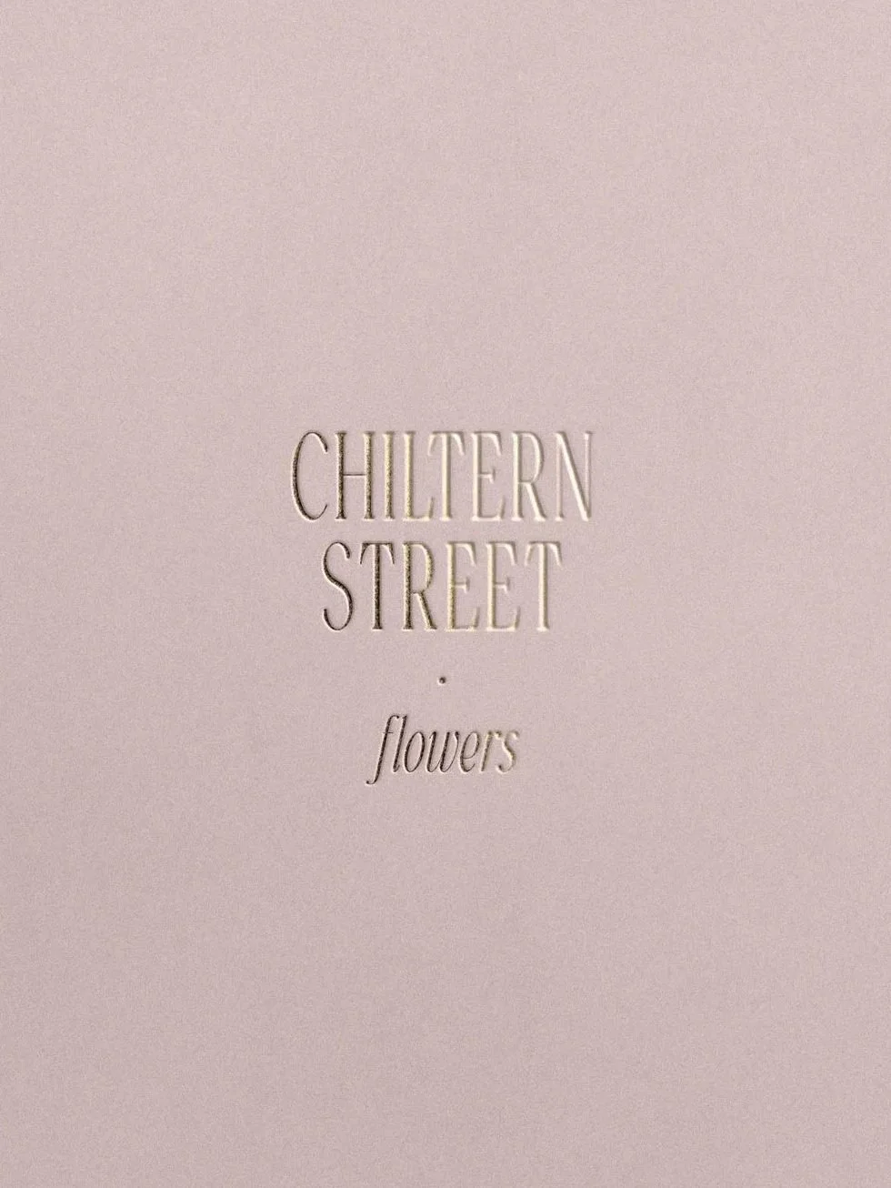 Light pink card with embossed text reading "Chiltern Street flowers" in elegant font.