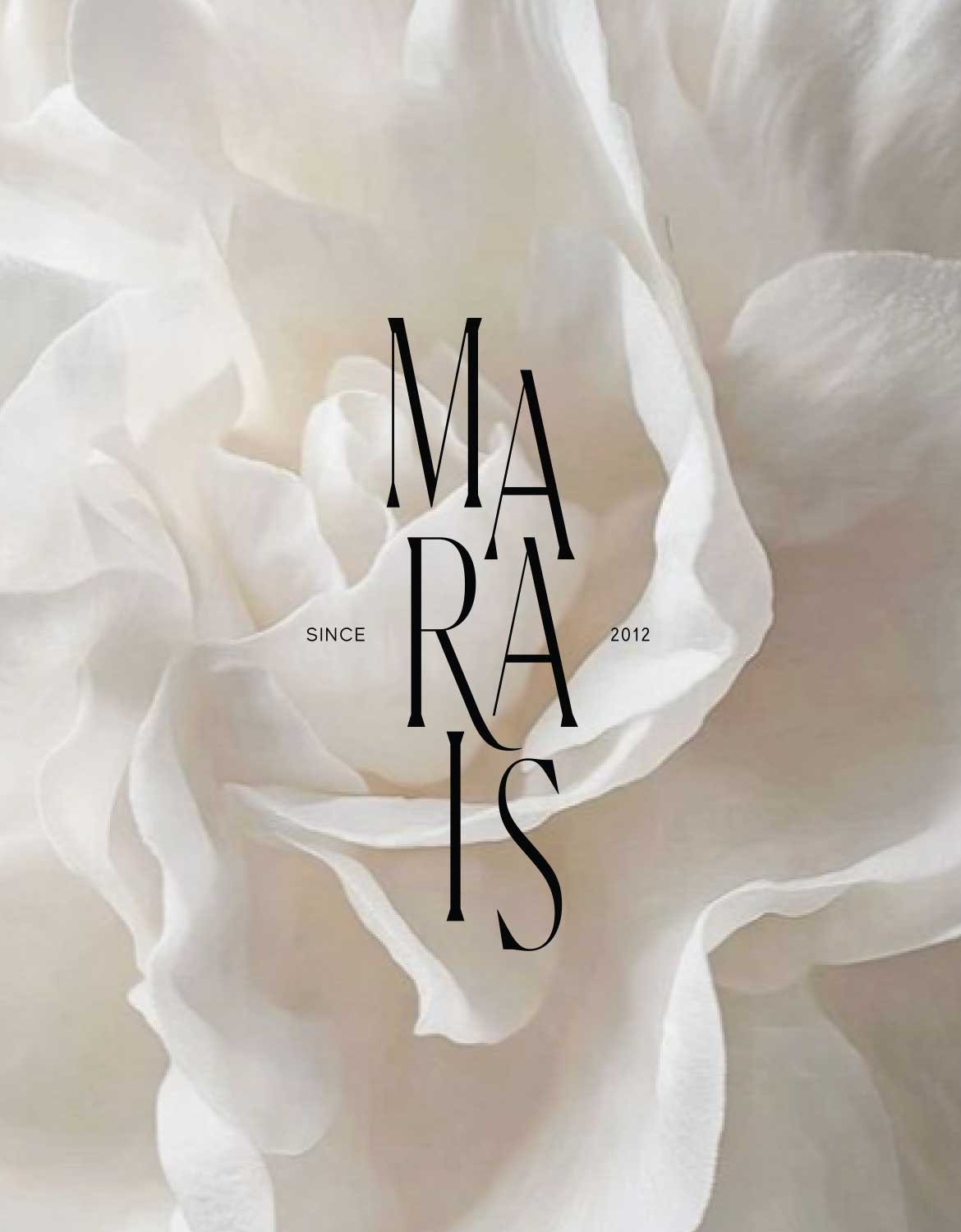 Close-up of a white flower with the words "Maria" and the phrase "Since 2012" overlaid in black text.