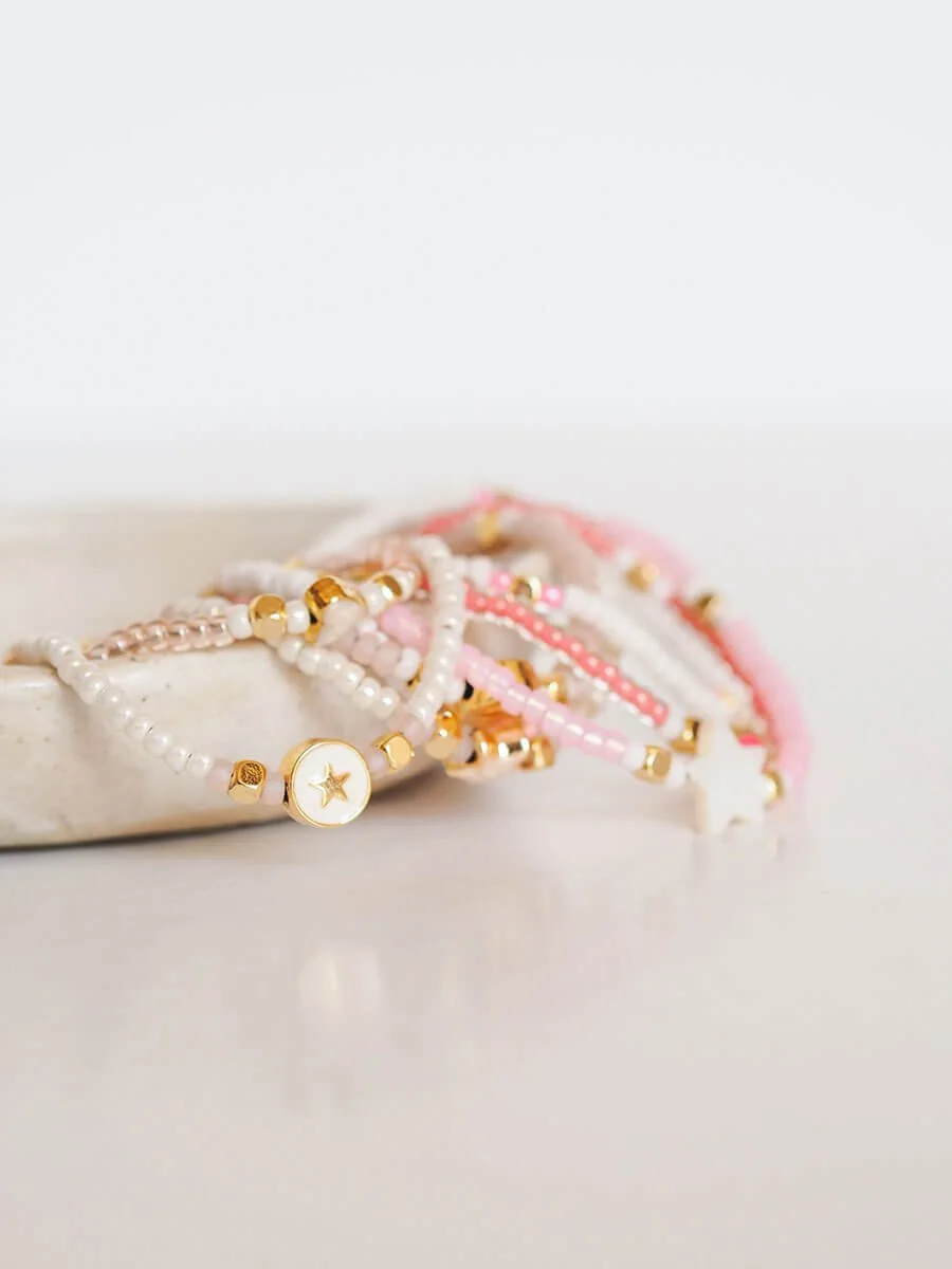 Depth of field product photography of pale pink beaded bracelets