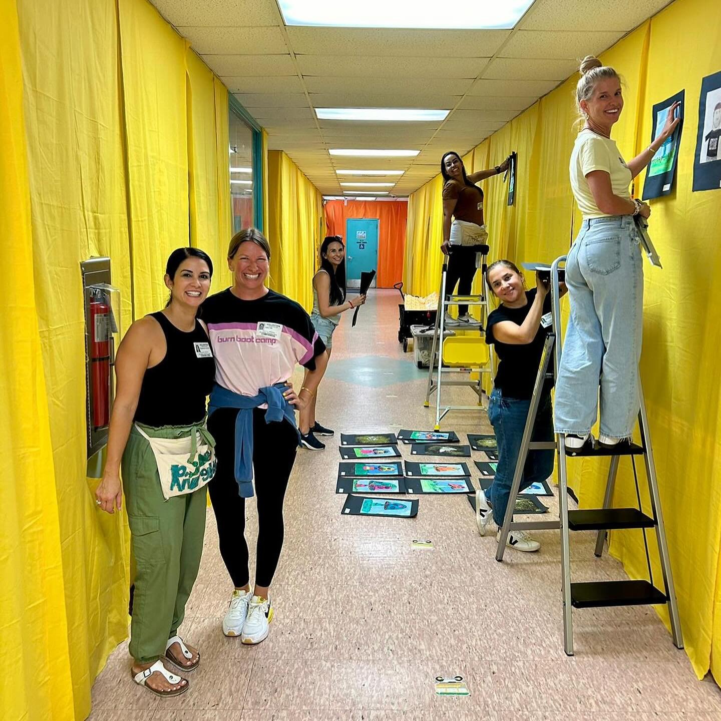 Preparations for Creative Arts Night are well underway!! This week we began preparing our student art gallery by hanging colorful fabric in the hallways and mounting artworks created by our 1,000+ students. Thank you to our amazing volunteers who hav