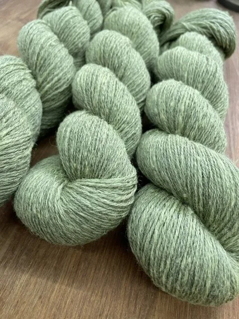 fingering weight sock yarn light moss green closeup