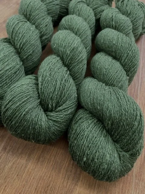 fingering weight sock yarn medium forest green closeup