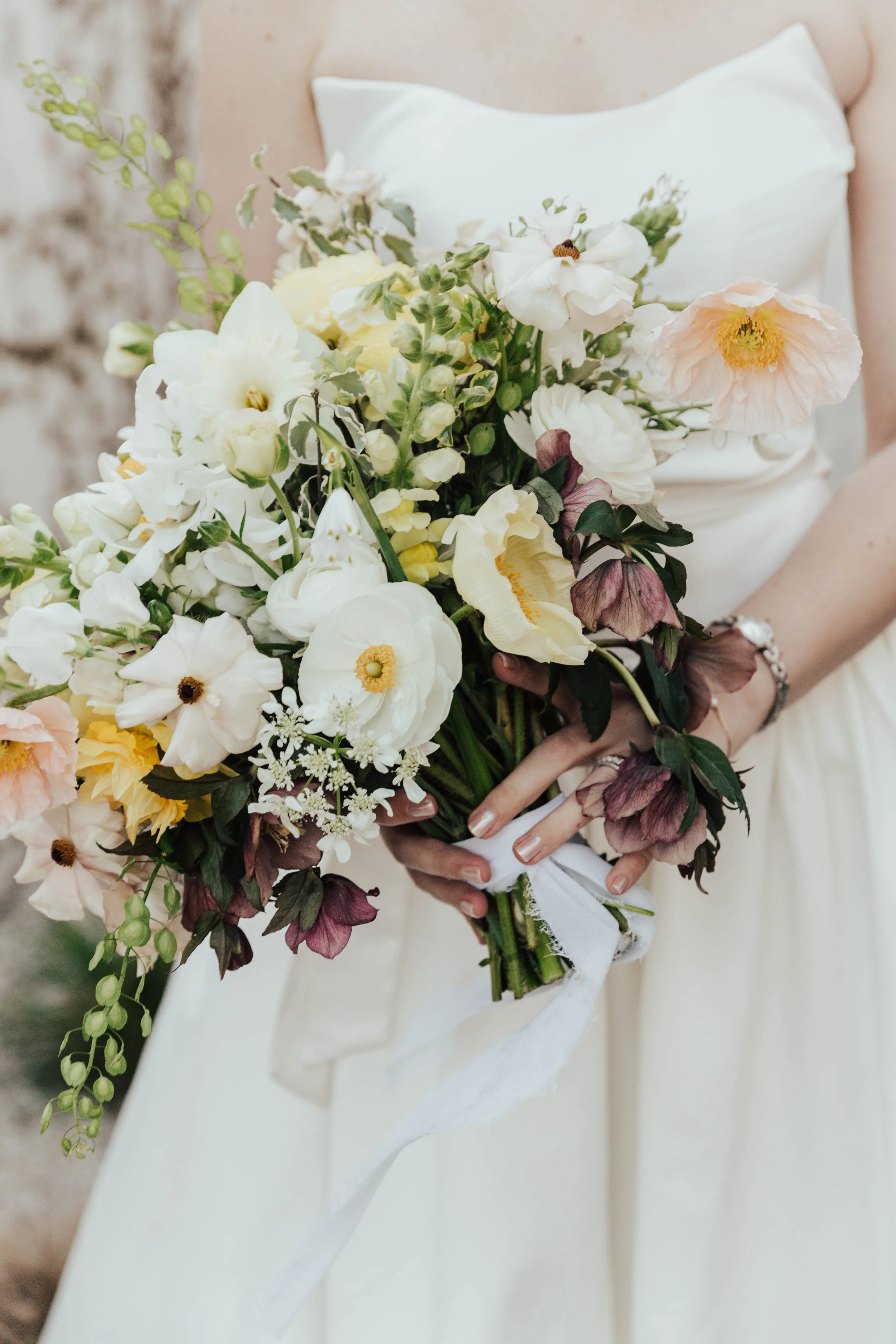 spring bridal bouquet butterfly ranunculus and poppies