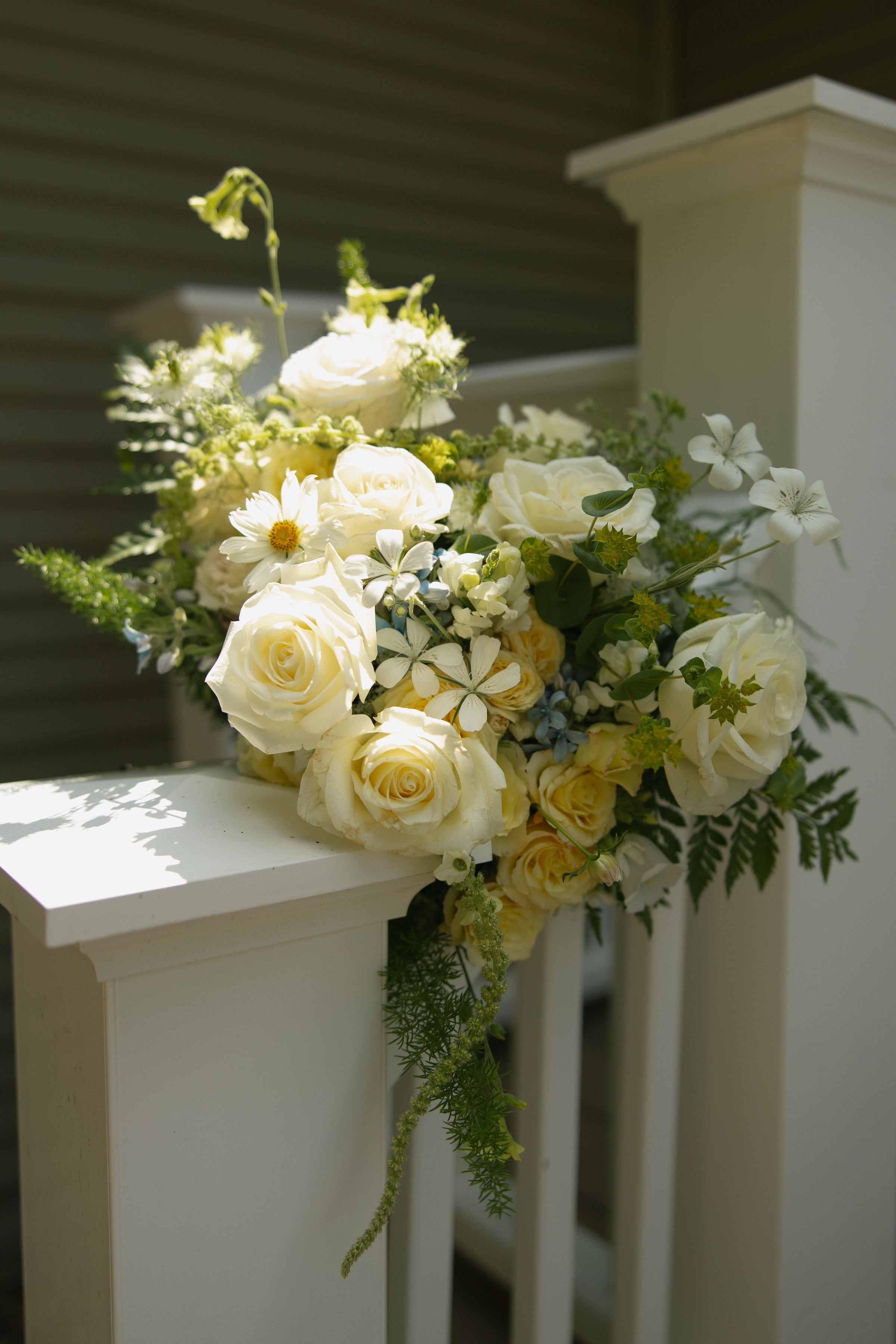 Local wedding bouquet with white and yellow roses in the sun