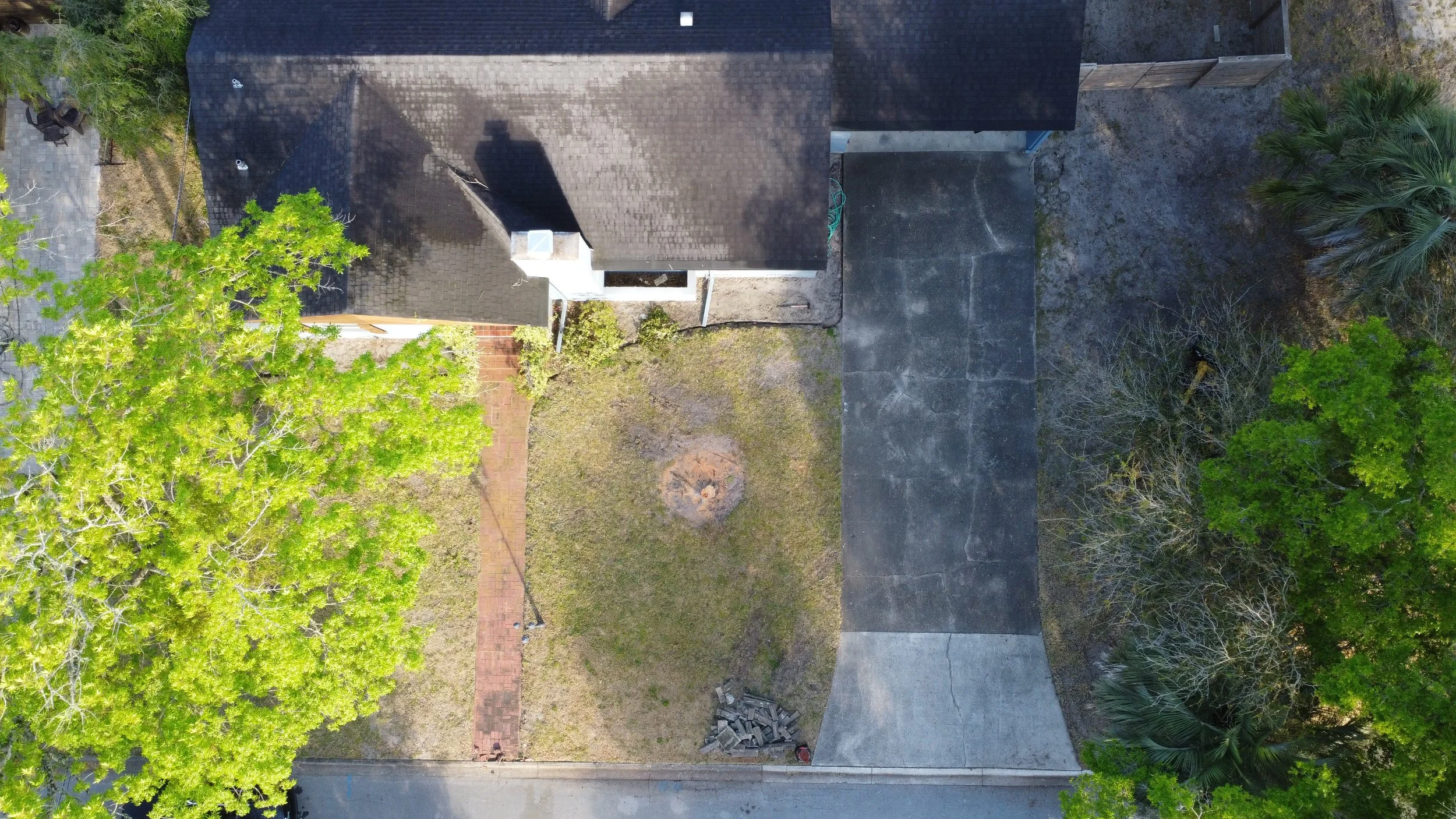 'Before' aerial image of a home with no landscape design.