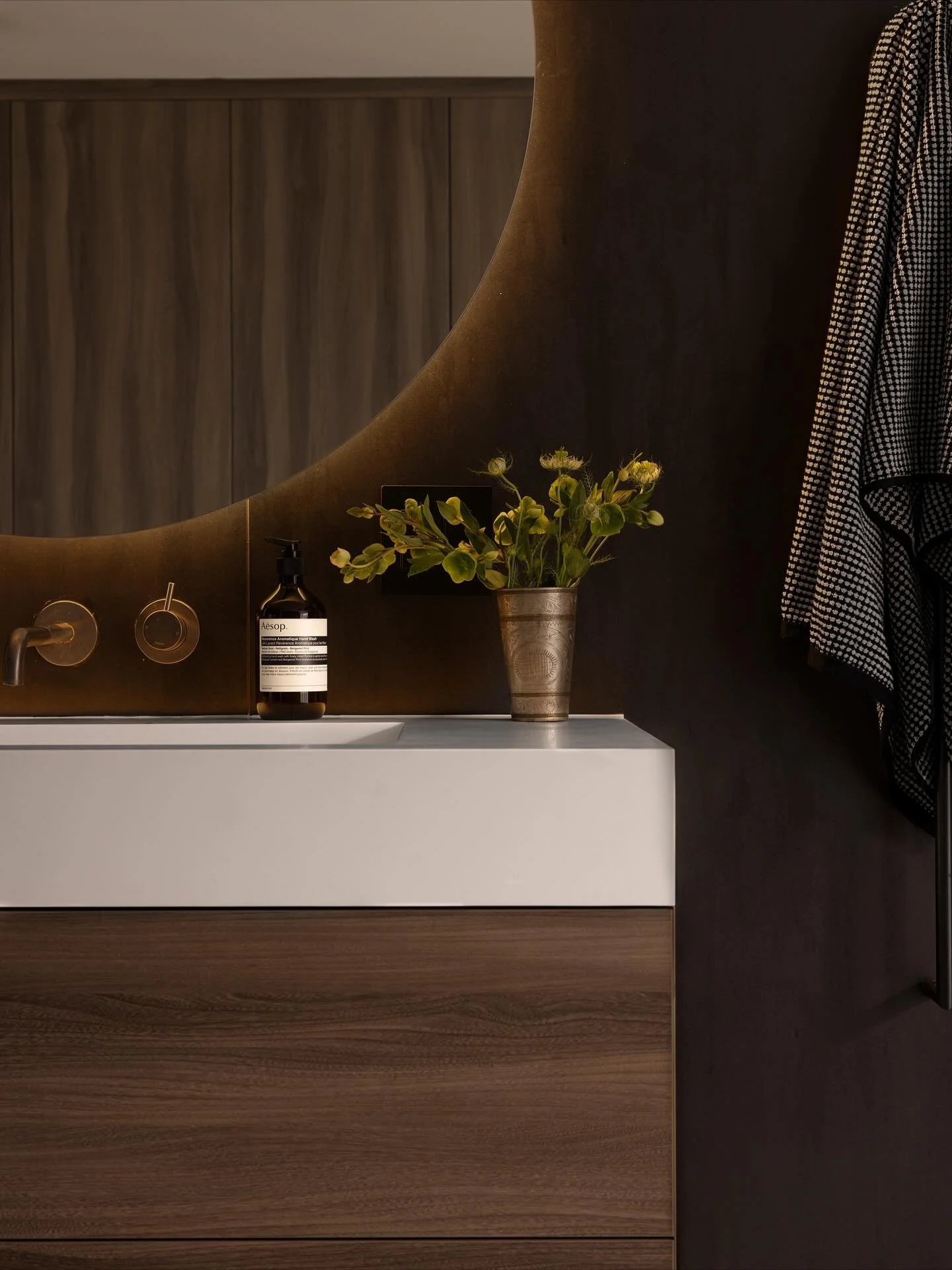 Does a black bathroom count as a Halloween themed post?

When your bathroom lacks windows and is naturally dark, sometimes the best answer is to embrace dark and moody 100%. 

The walls in this Del Mar master are clad in massive porcelain slabs which