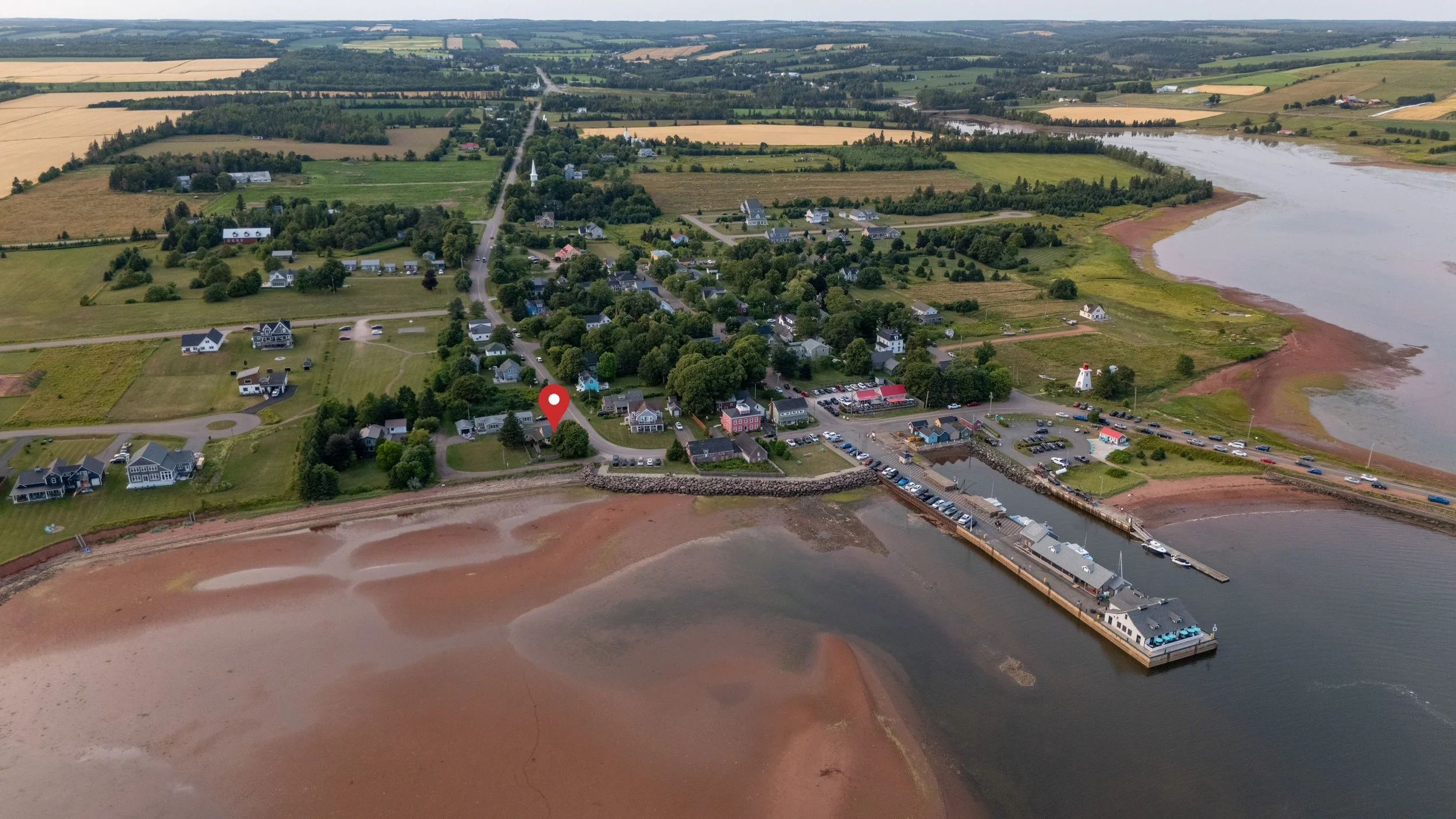 Aerial view of picturesque Victoria-by-the-Sea, PEI including the wharf and waterfront area of the town.  