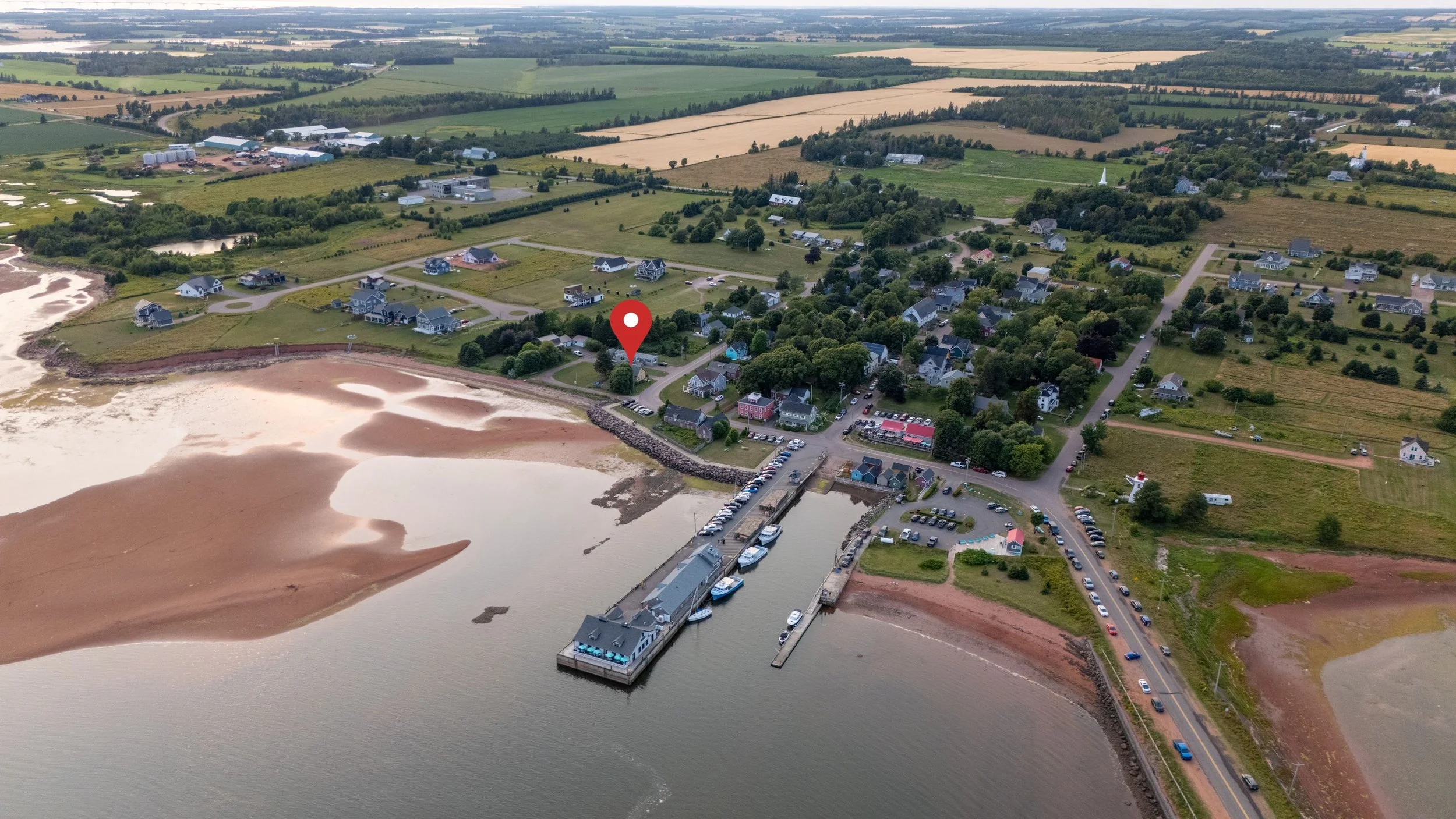 Aerial view of picturesque Victoria-by-the-Sea, PEI including the wharf and waterfront area of the town.  