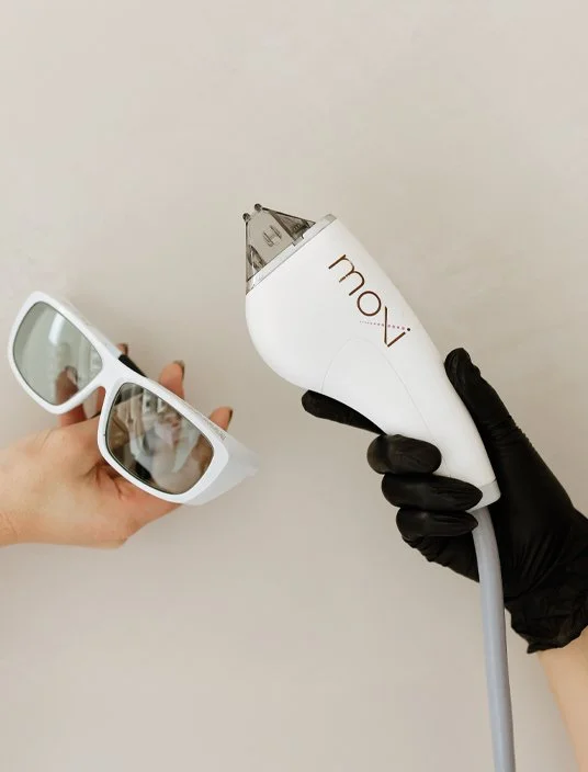 Provider holds the Sciton MOXI laser handpiece and protective eyewear used during treatment at Reviv Lounge in Oconomowoc, Wisconsin.