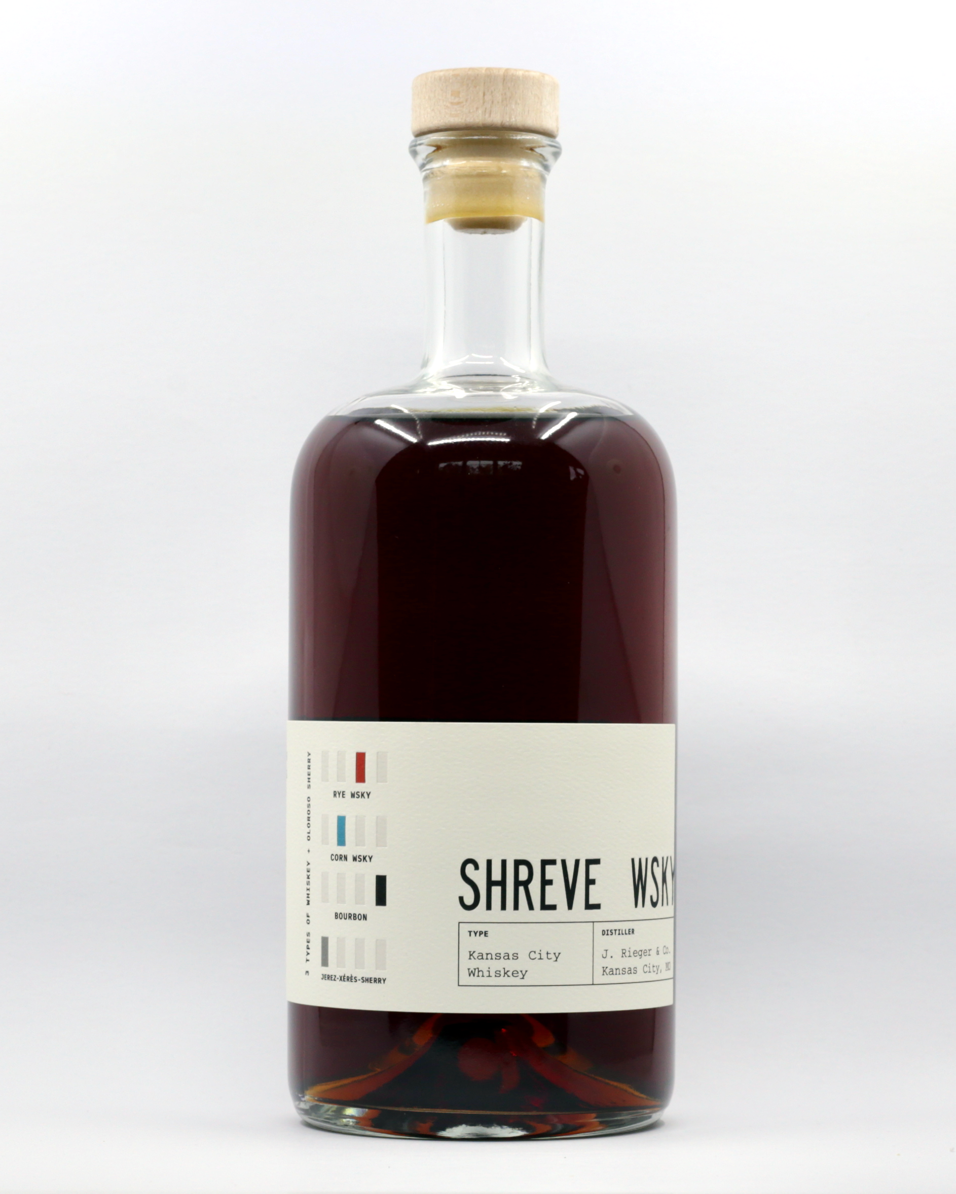 A bottle of Shreve Whiskey with a cream label that and black text and colored boxes, showing details like Kansas City Whiskey and Bourbon. The bottle is set against a white background.