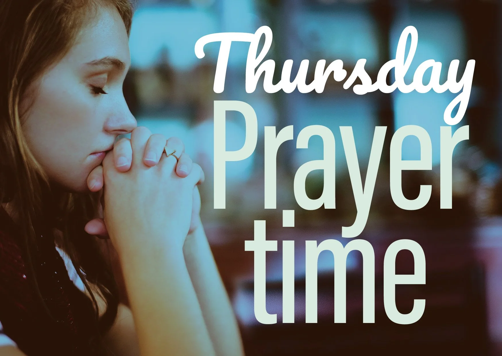 A young woman praying with her eyes closed