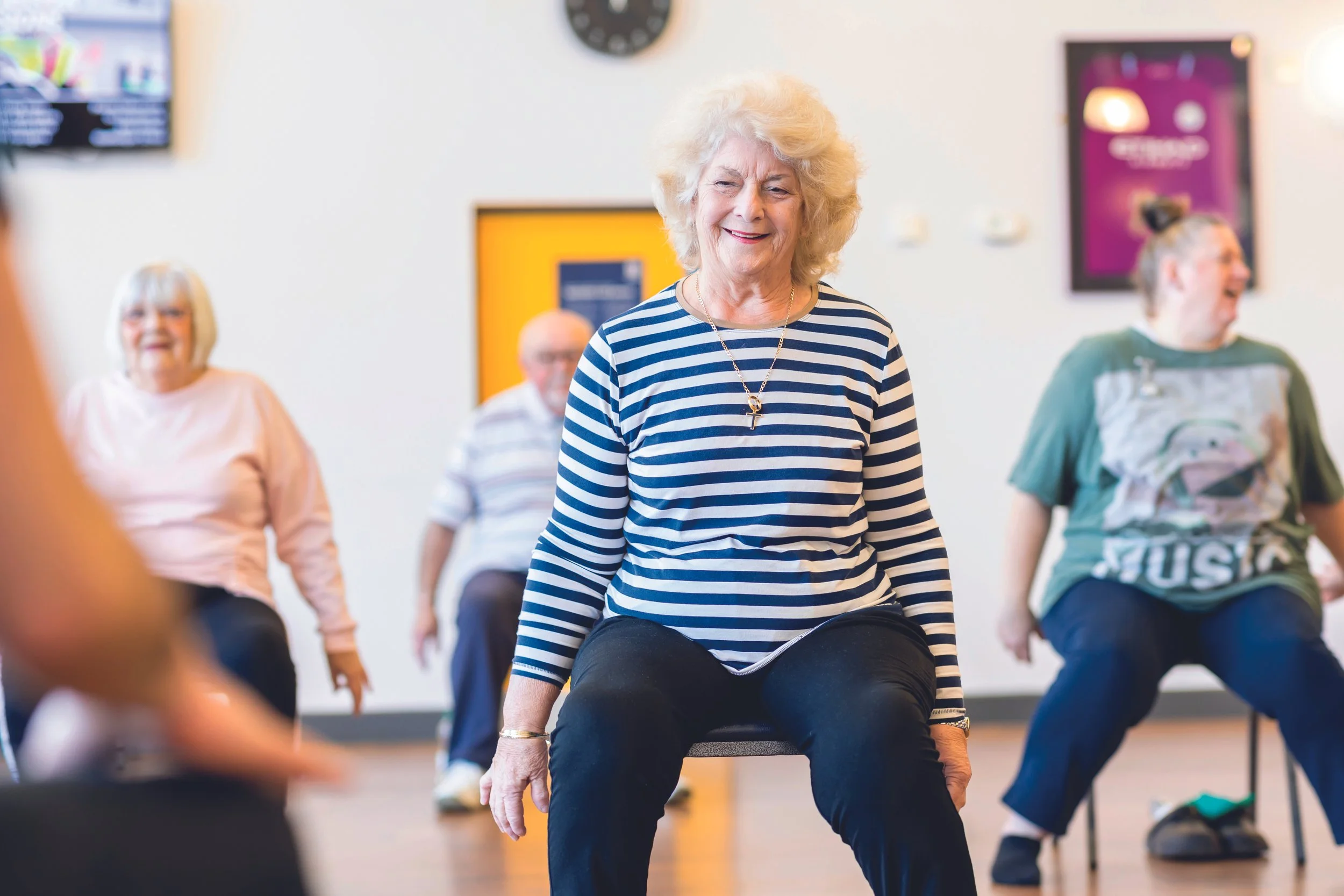 group of older people doing seated chair exercises