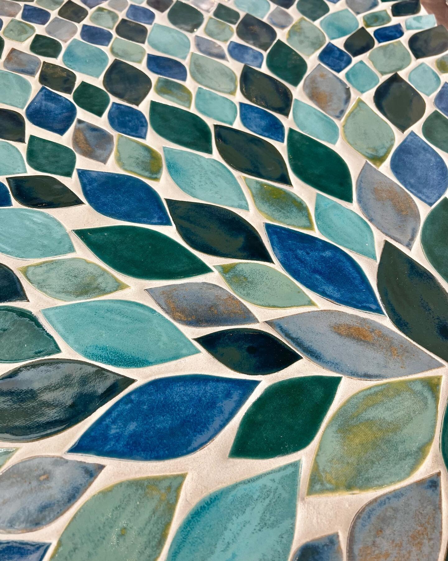 Our leaf tiles in a mix of blue glazes.  #leaves