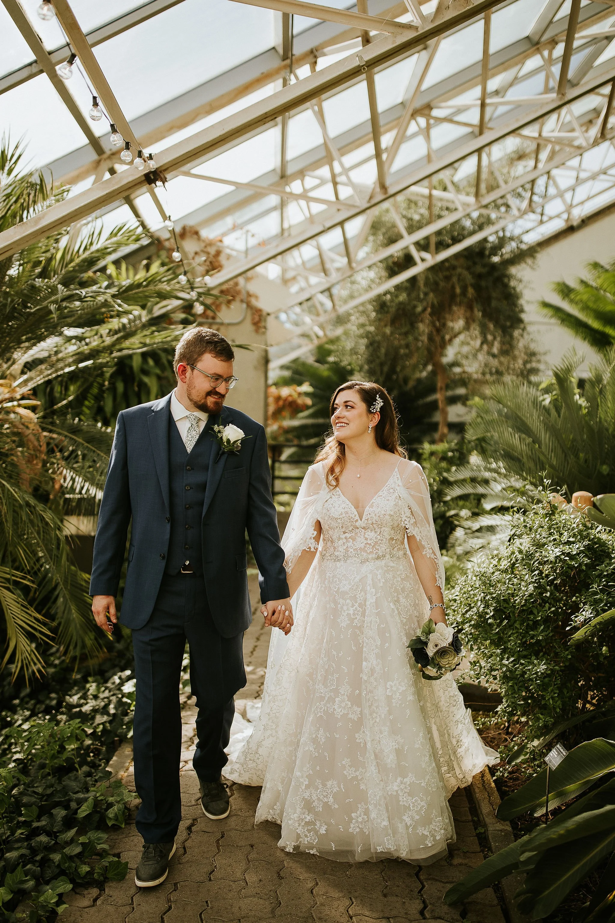 A bride at her husband smile just after their fairy-tale wedding in Fort Wayne, IN, planned by bella and fern event planning.
