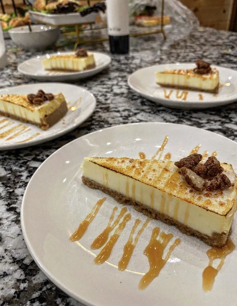 Bruleed Cheesecake with candied pecans and caramel drizzle