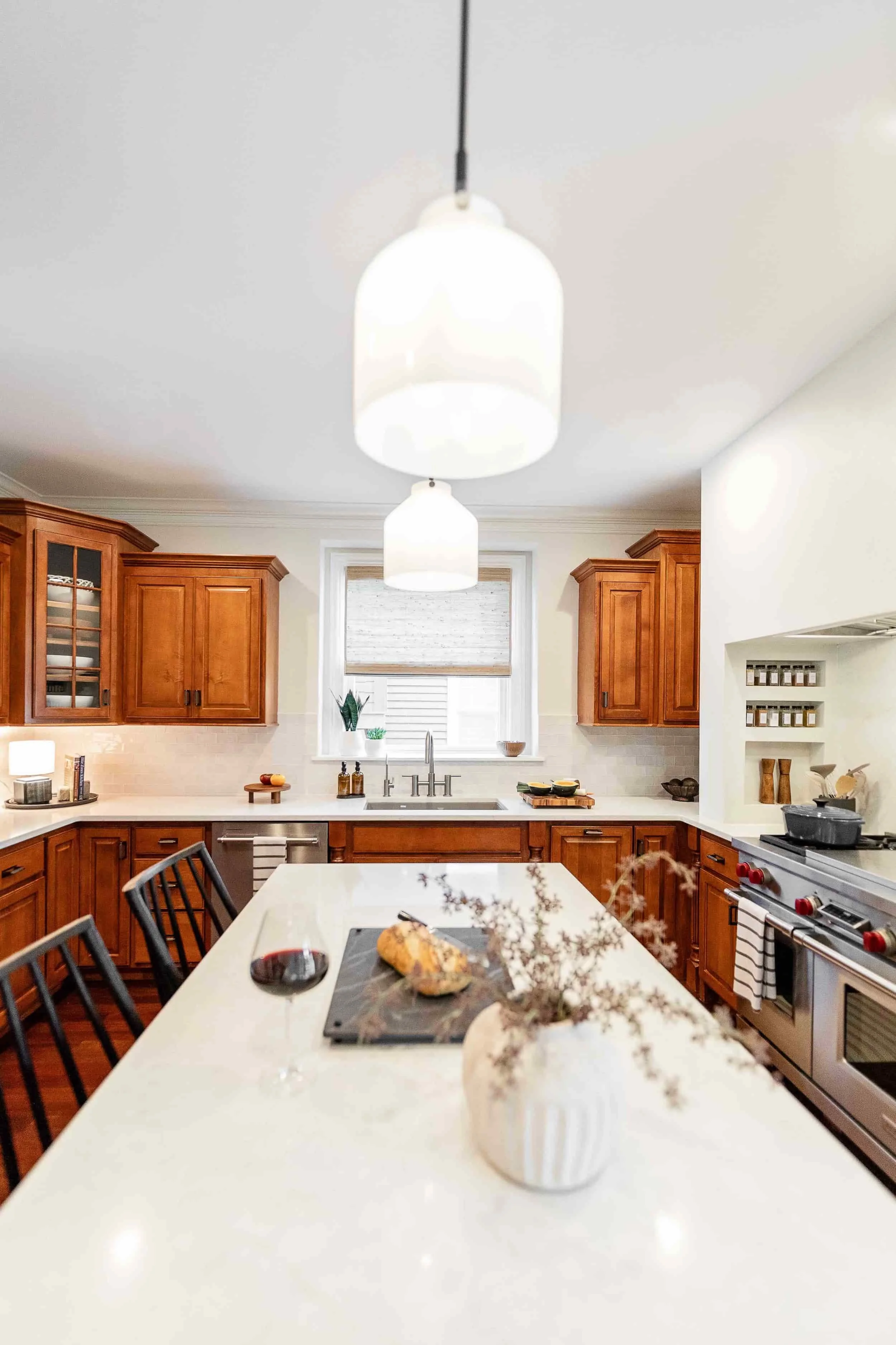 Light colored countertops and cherry cabinets