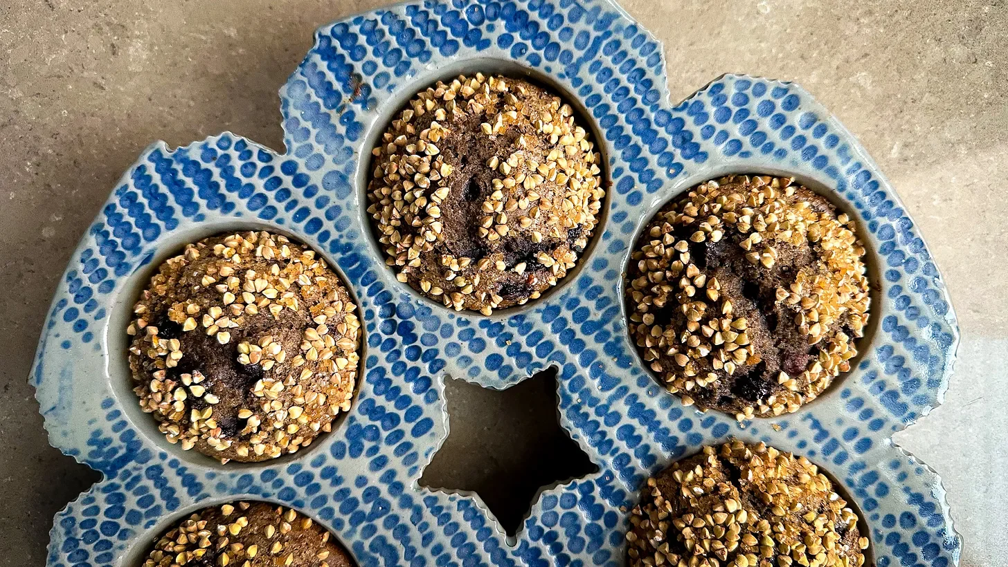Buckwheat muffins in a handmade ceramic muffin pan.