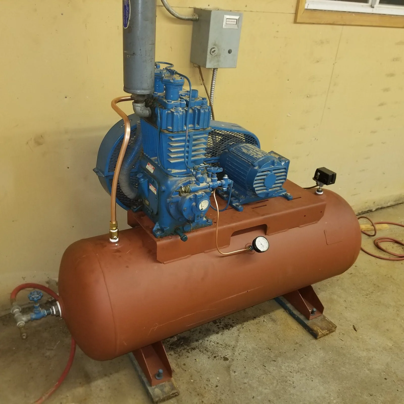 A Quincy QR Series 5 HP air compressor mounted on a new horizontal tank installed by The Compressor Guy, LLC.
