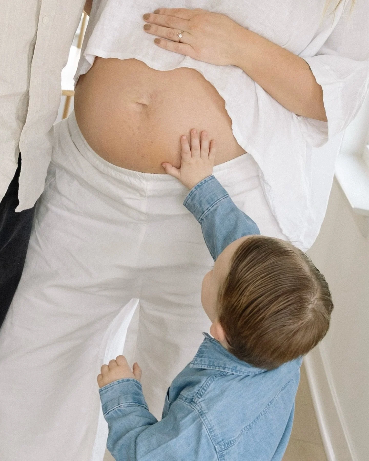 At home photos for this radiant growing family. 
.
.
.
🎞️ indianapolis family photographer, film family photography, maternity session at home, all white maternity outfit, real life moments, childhood magic