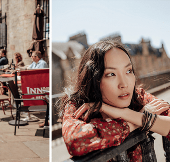 Promod 2018 collection - model leans over wrought iron fencing. She wears a floral pattern blouse