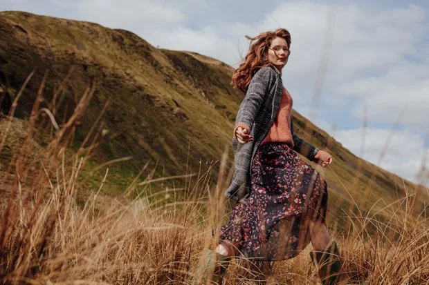 Promod 2018 collection -Model runs down through long grass on Artur's Seat Edinburgh