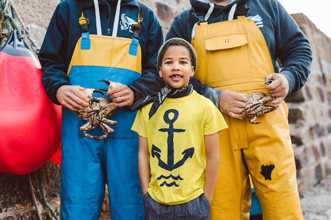 Young Boy wearing yellow T-Shirt with a big anchor printed on the front from Tea collection 2017
