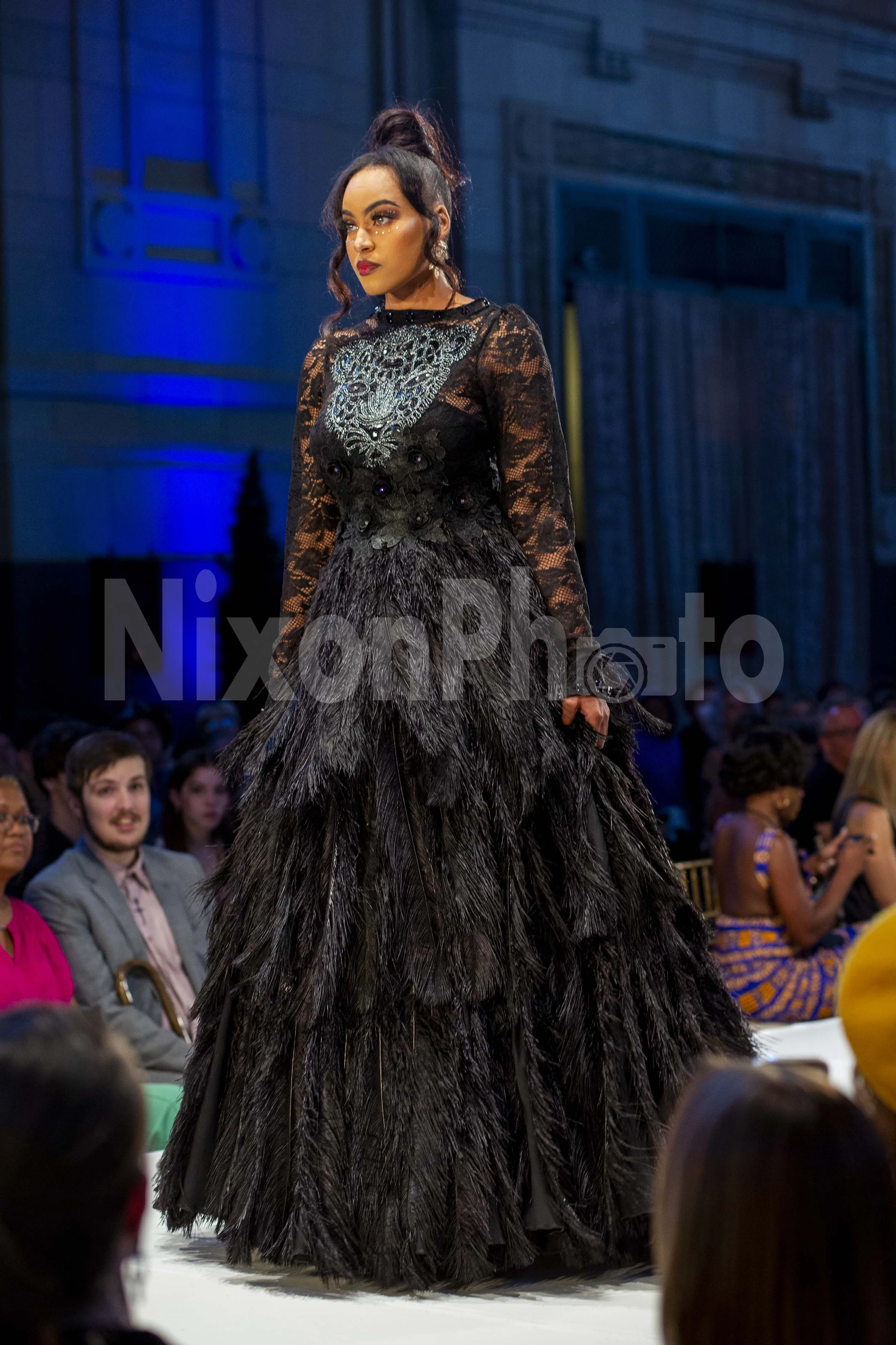 Model in black textured gown on runway