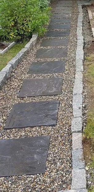 Stepping-stone walkway set in gravel with granite edging