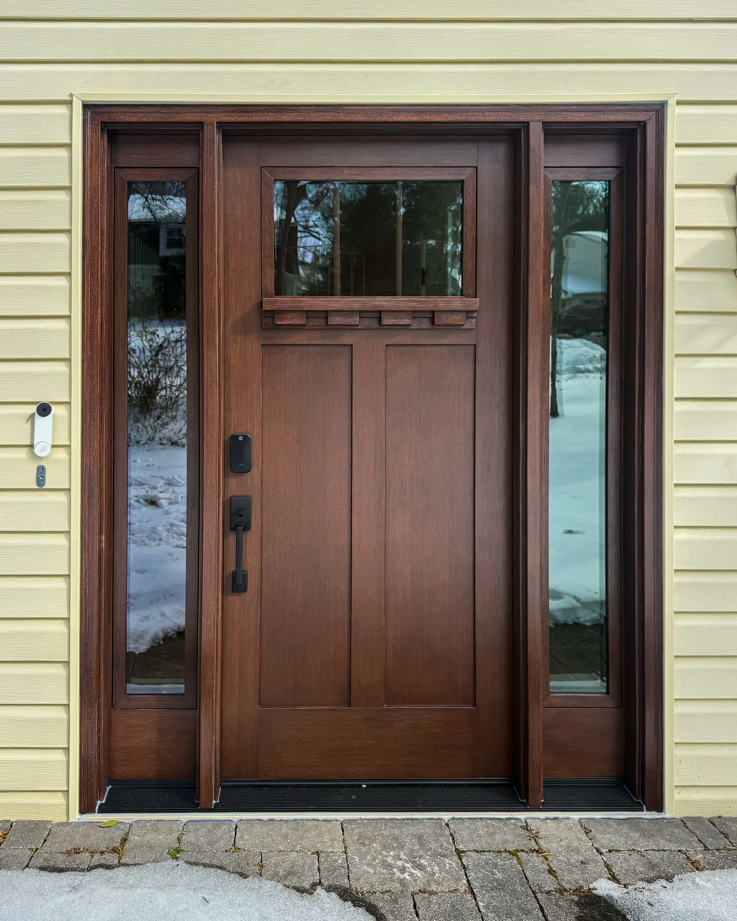 This ProVia fiberglass entry door is a 420-DS style paired with a single panel double sidelite, featuring the fir woodgrain texture and a Truffle stain finish.