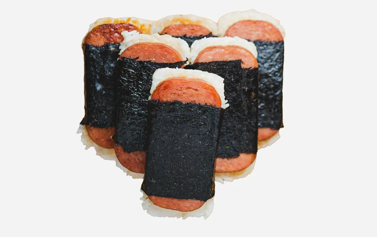 Hawaiian snack with a grilled, teriyaki-glazed, slice of Spam on top of a block of rice, wrapped together with a strip of nori (dried seaweed).