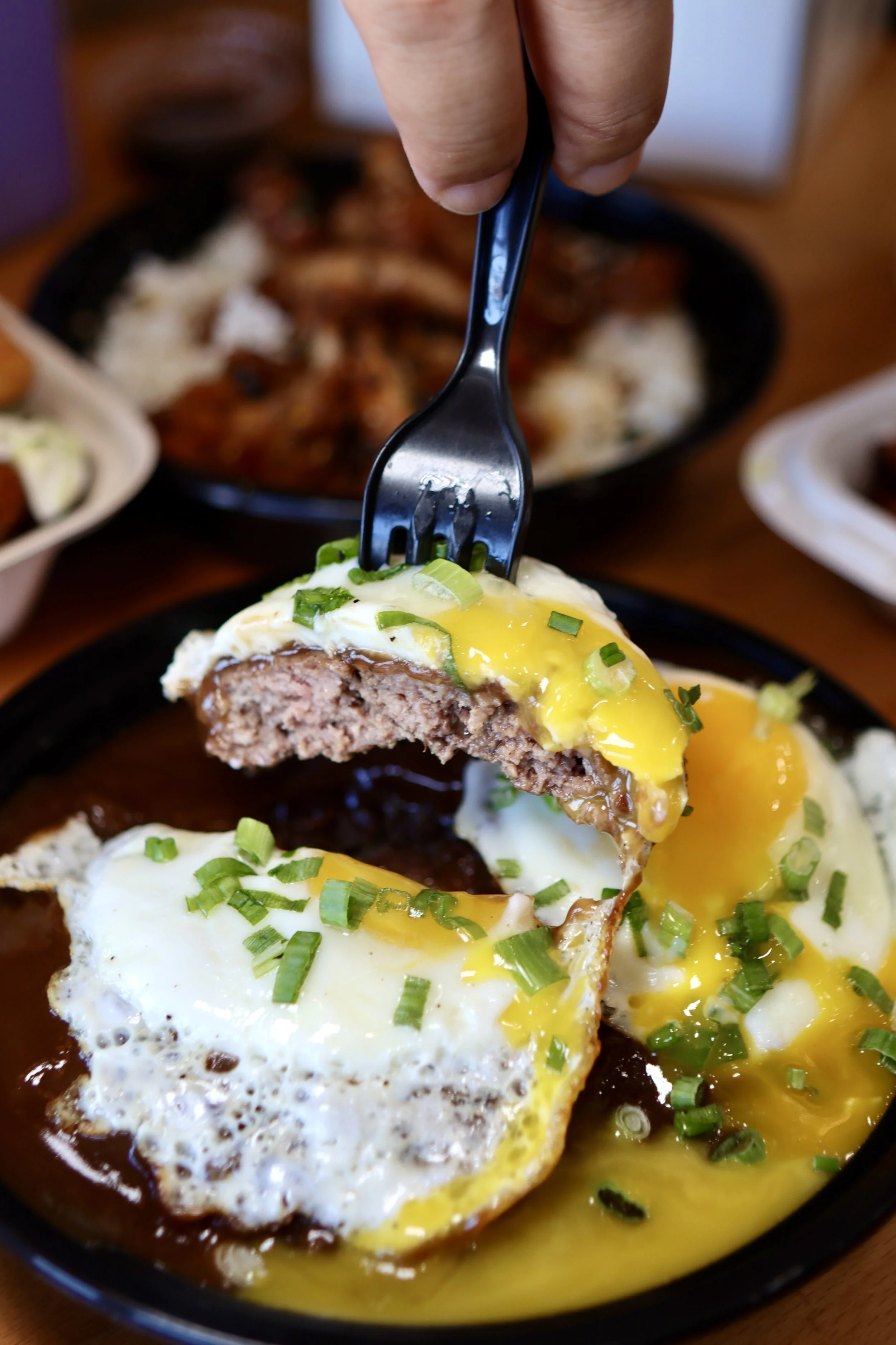 Image of Loco Moco special menu item with beef patties, brown gravy, sunny side up egg over rice.