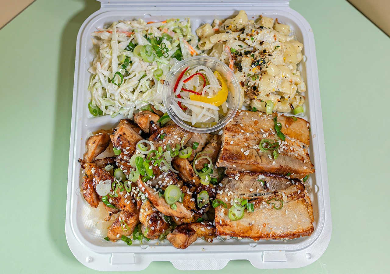 Chicken of any type plus pork belly combination plate over rice with side of house slaw and macaroni salad.