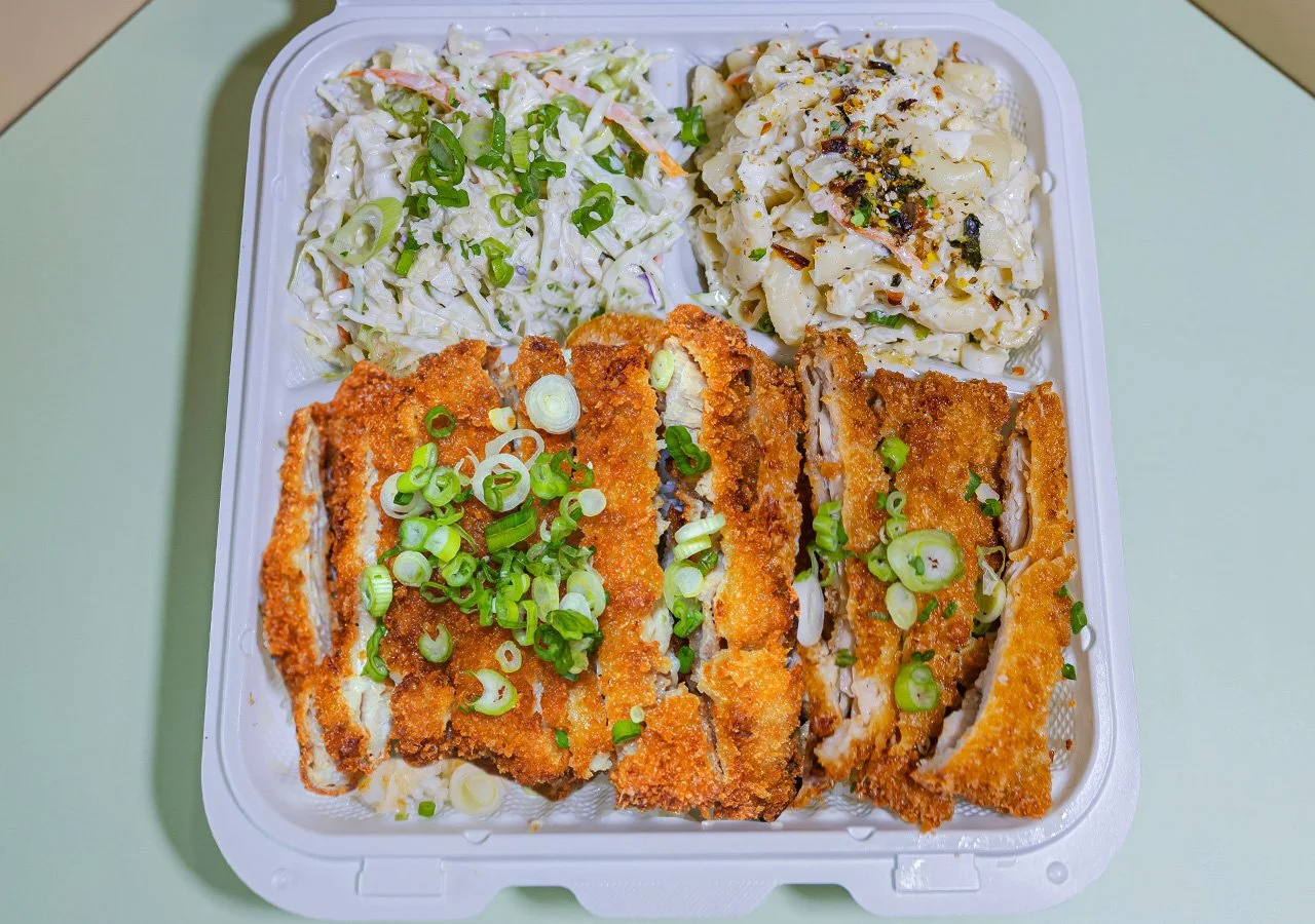 Single item plate of Katsu chicken over white rice with side of slaw and house macaroni salad.