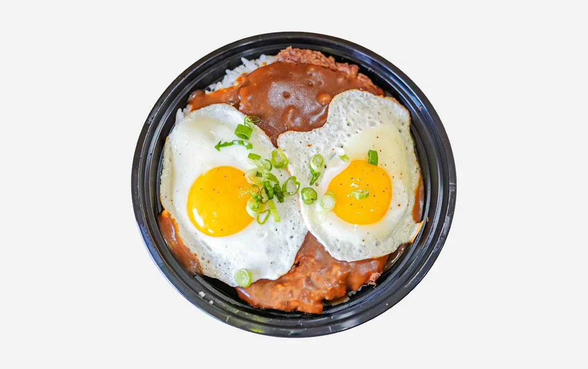 Hawaiian comfort food dish consisting of white rice topped with hamburger patties, two fried eggs, and brown gravy with green onion seasoning.