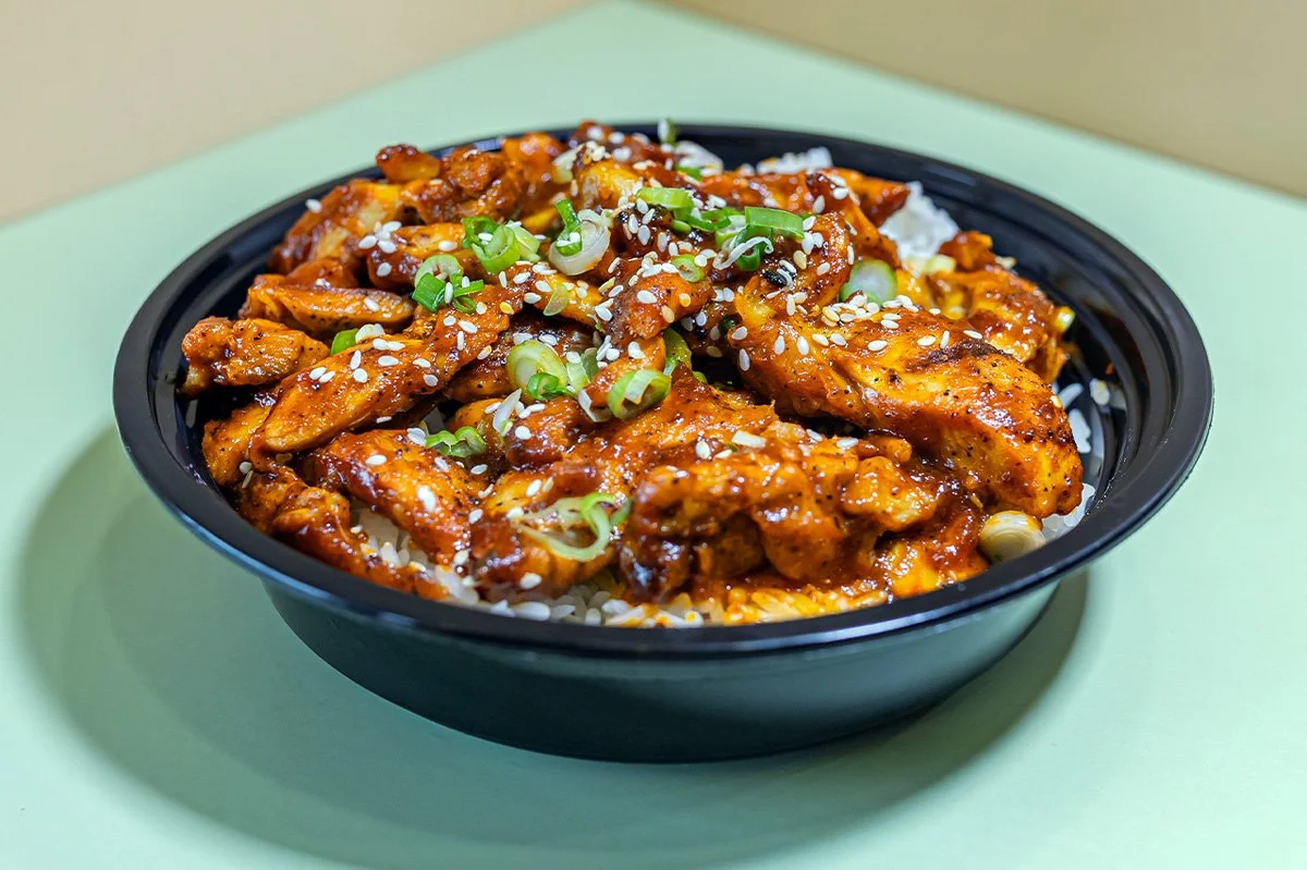 A bowl of Sweet Tangy BBQ Grilled Chicken served with two scoops of white rice.