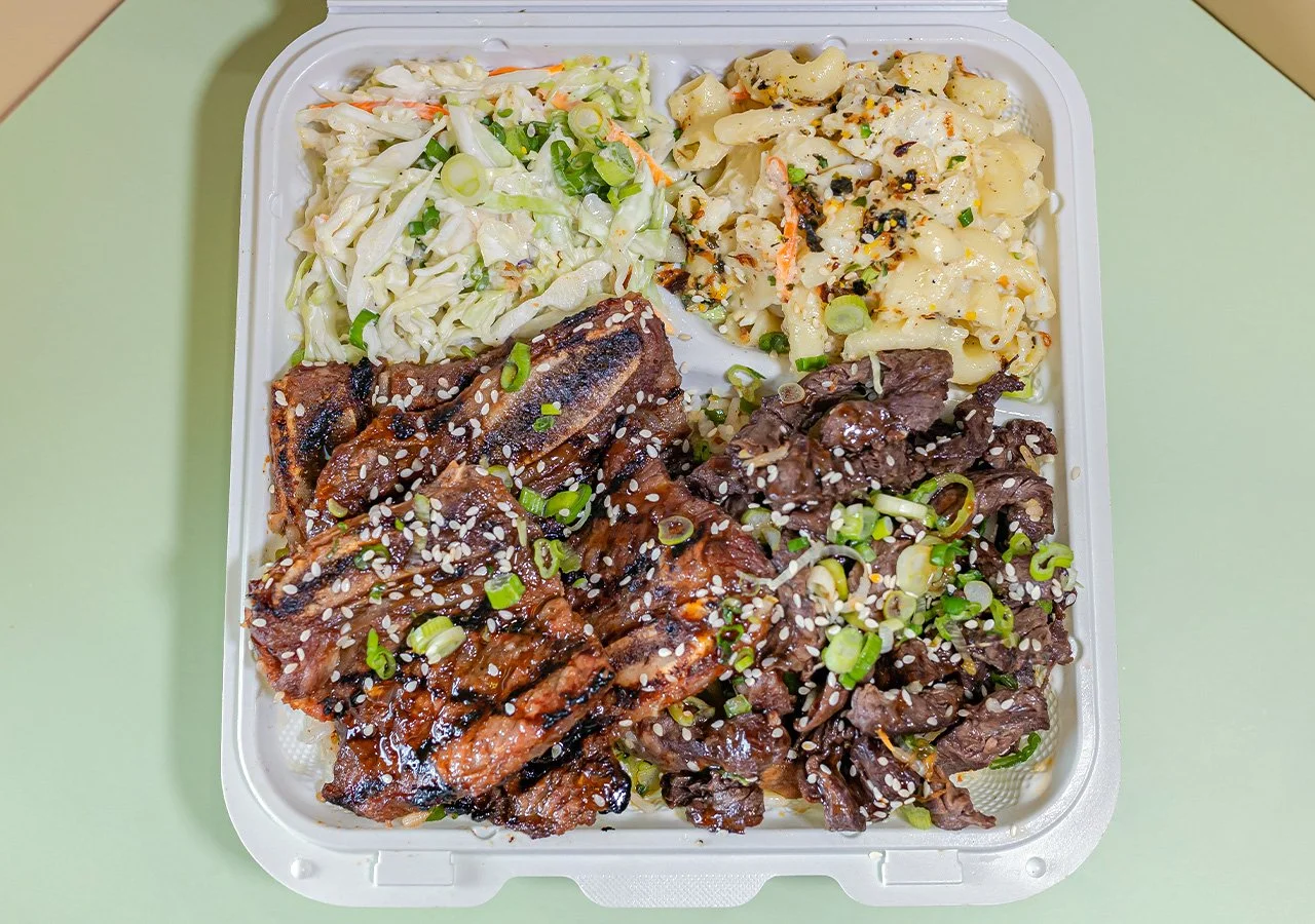 Kalbi beef short rib plus teriyaki beef combination plate over rice with side of house slaw and macaroni salad.