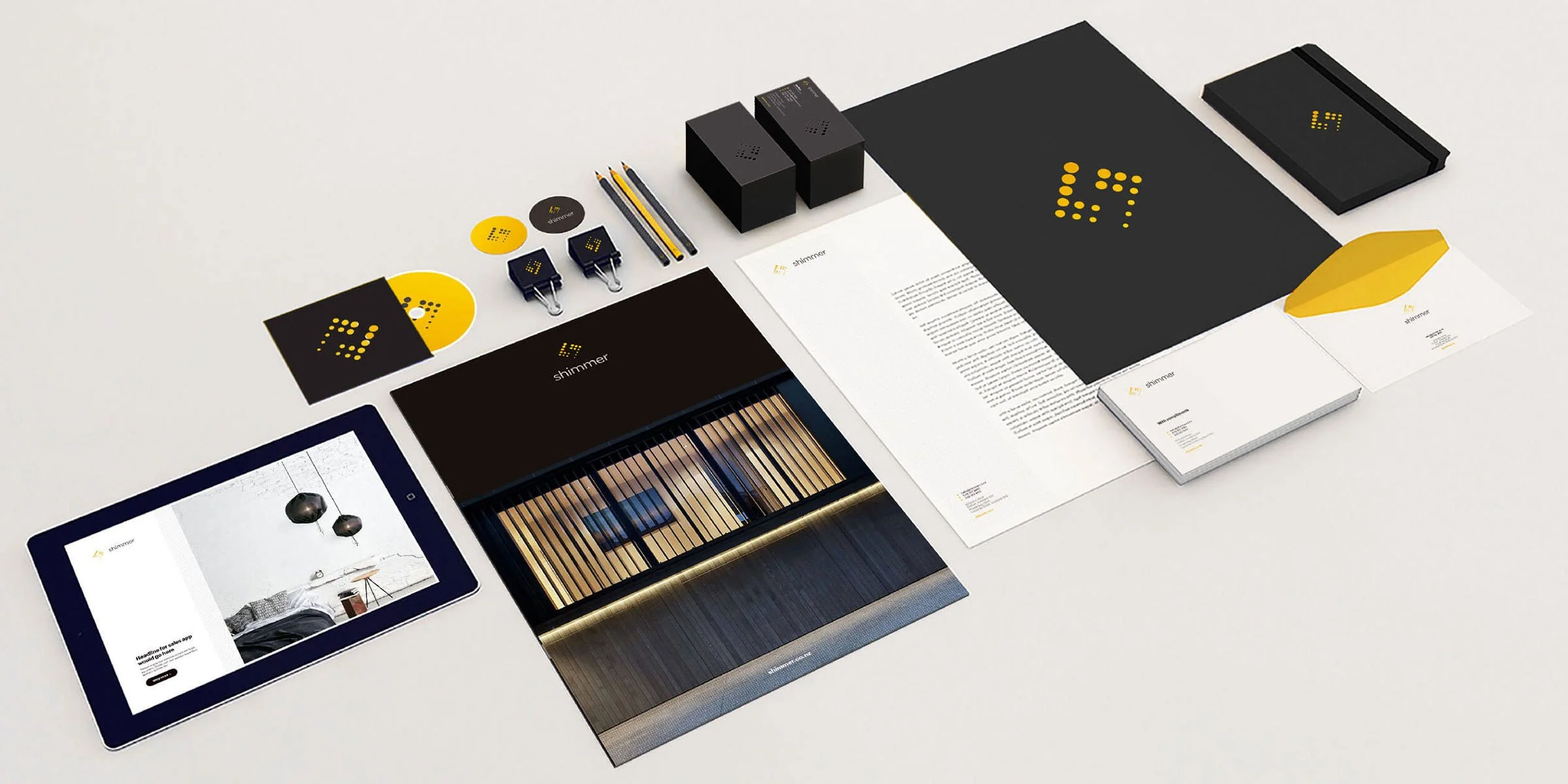 Kevin Schluter Design | Shimmer Branding | Application | A collection of branding and marketing materials forShimmer, including a tablet displaying a website, printed brochures, business cards, pens, and digital devices.