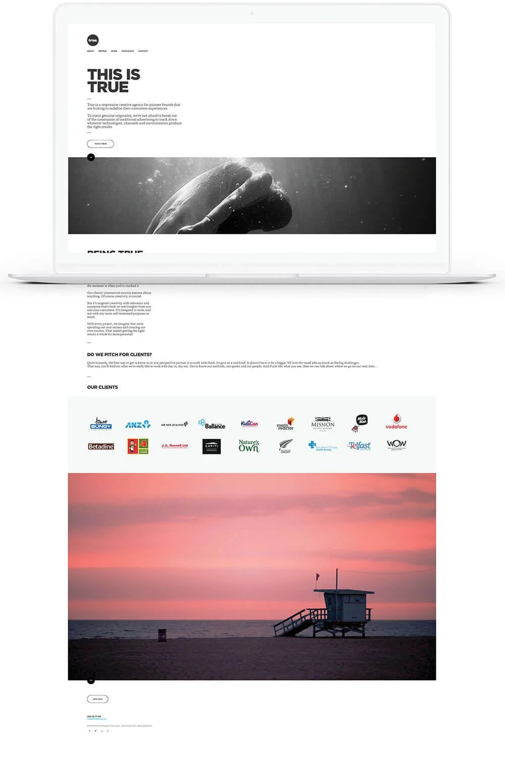 A website homepage displayed on a laptop screen, showcasing a black and white image of a swimmer underwater, a section of client logos, and a large photograph of a lifeguard tower at sunset on the beach.