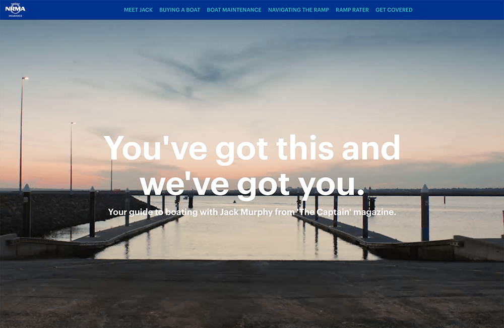 Kevin Schluter Design | IAG | NRMA | A marina dock extending into calm water at sunset with a pastel sky, and a website header with navigation options and large text saying 'You've got this and we've got you'.