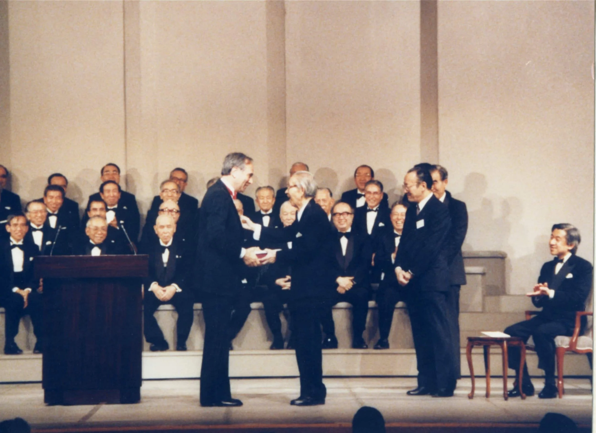 Theodore Maiman receives Japan Prize from Mr Matsushita during 1987 Ceremony. Seated far rightist Crown Prince Akihito, then Emperor Akihito. Courtesy of Japan Prize Foundation.