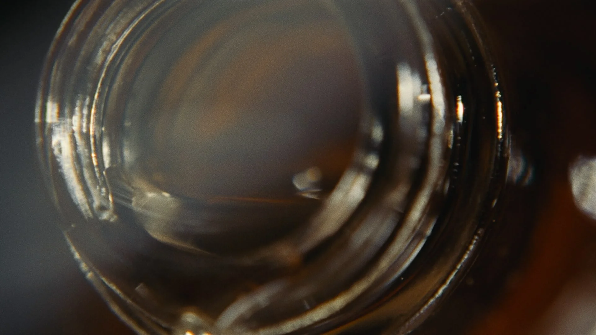 Close-up of the inside of a brown glass bottle.