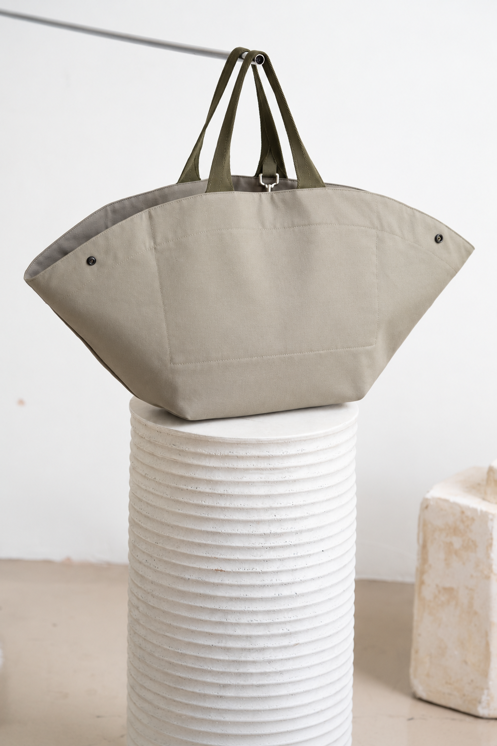 Minimalist Canvas Tote on Textured Pedestal.png