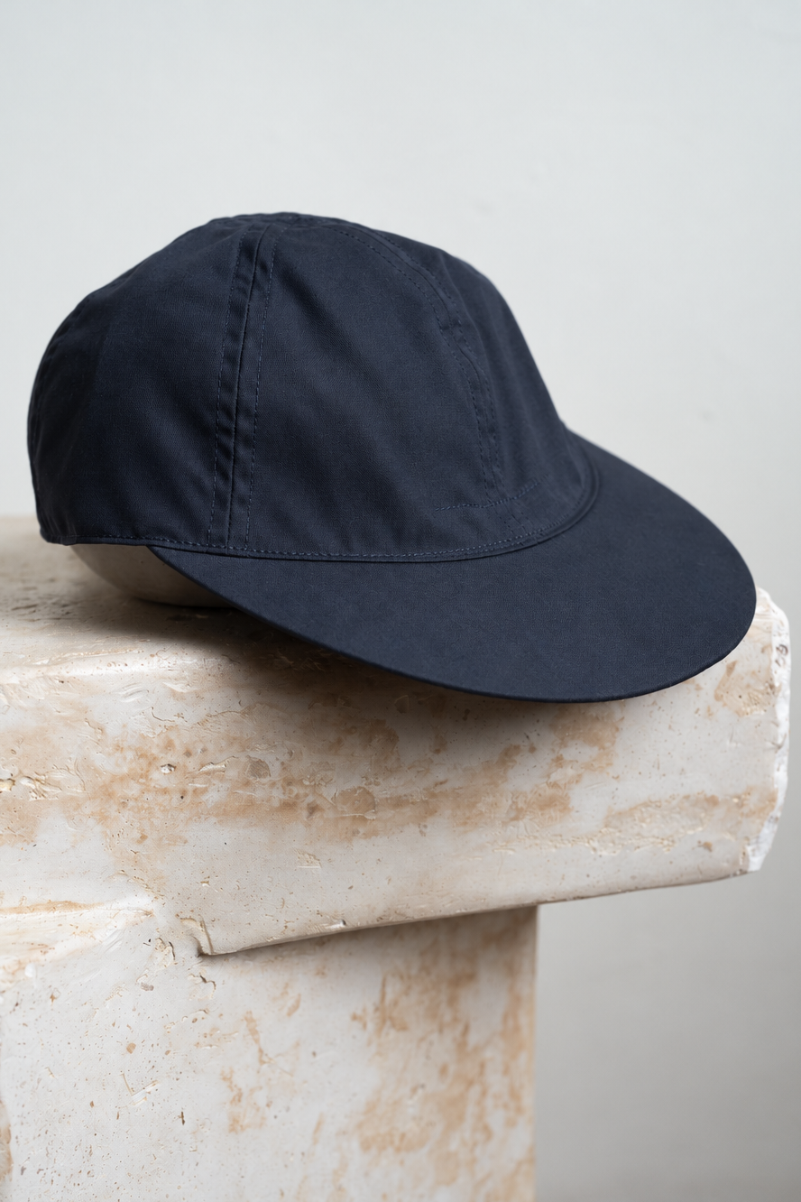 Navy+Cap+on+Textured+Stone.png
