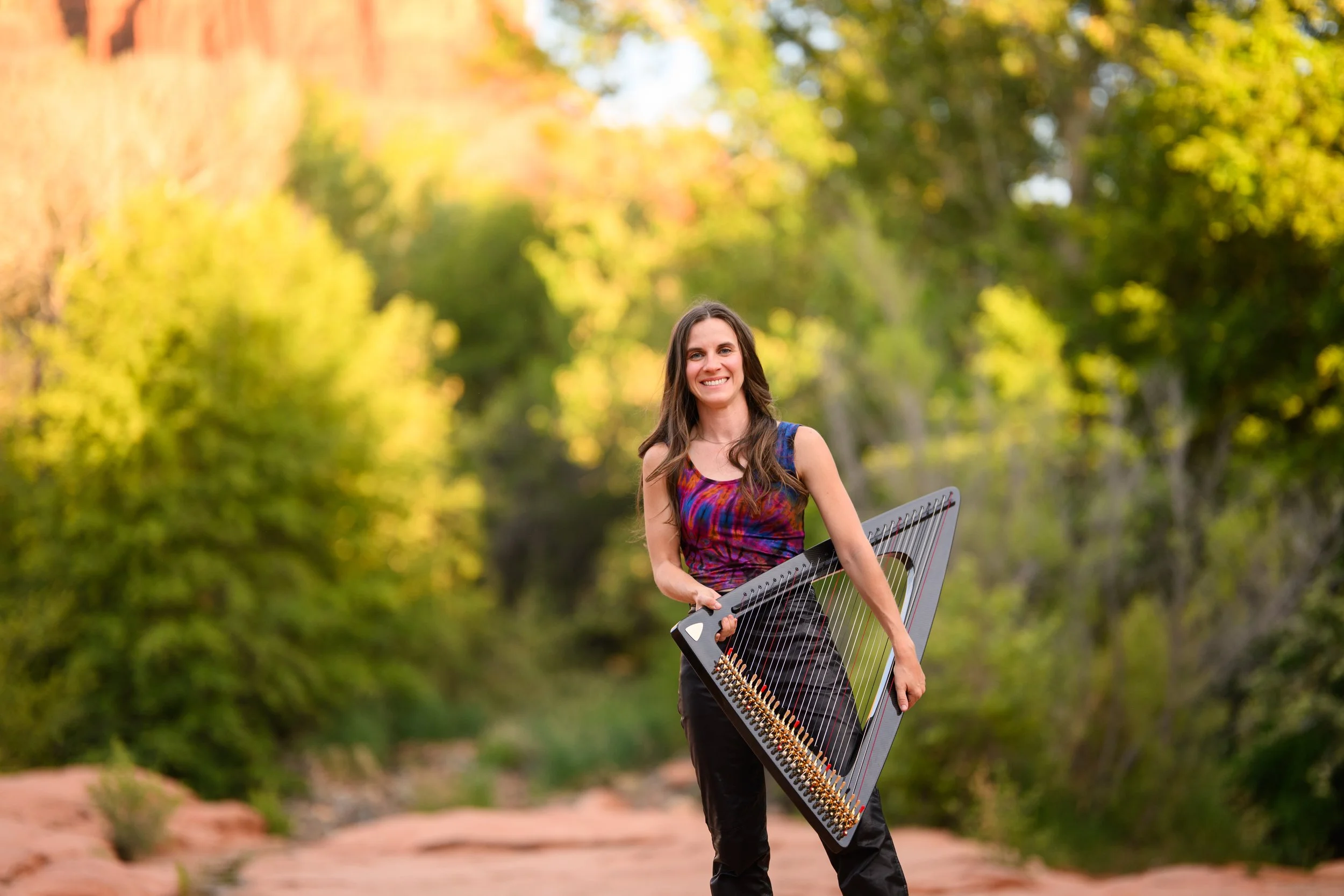 A woman playing a harp on a in Arizona wedding harpist red rocks