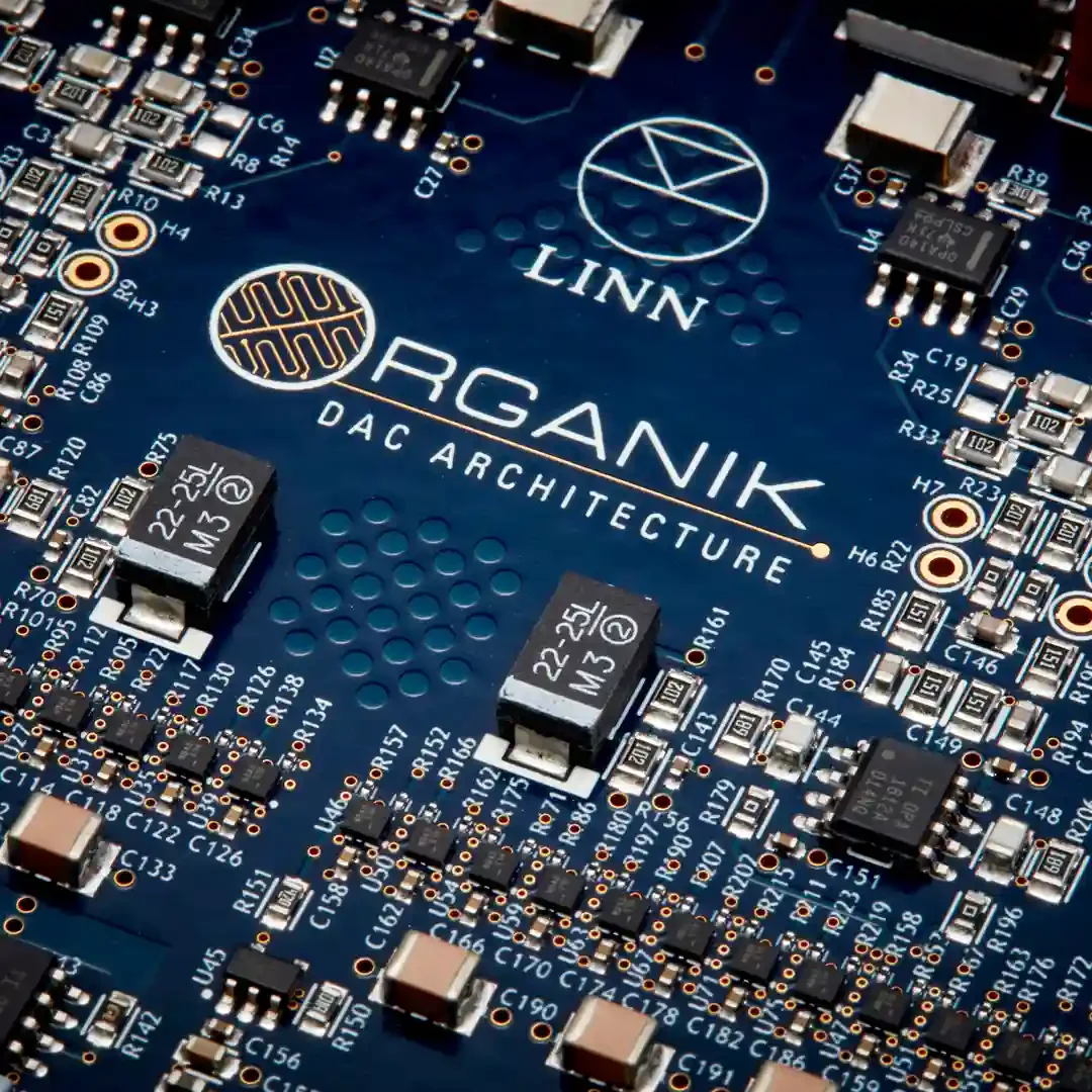 Close-up of a Linn printed circuit board with various electronic components and the logo and text 'ORGANIK DAC ARCHITECTURE' printed on it.