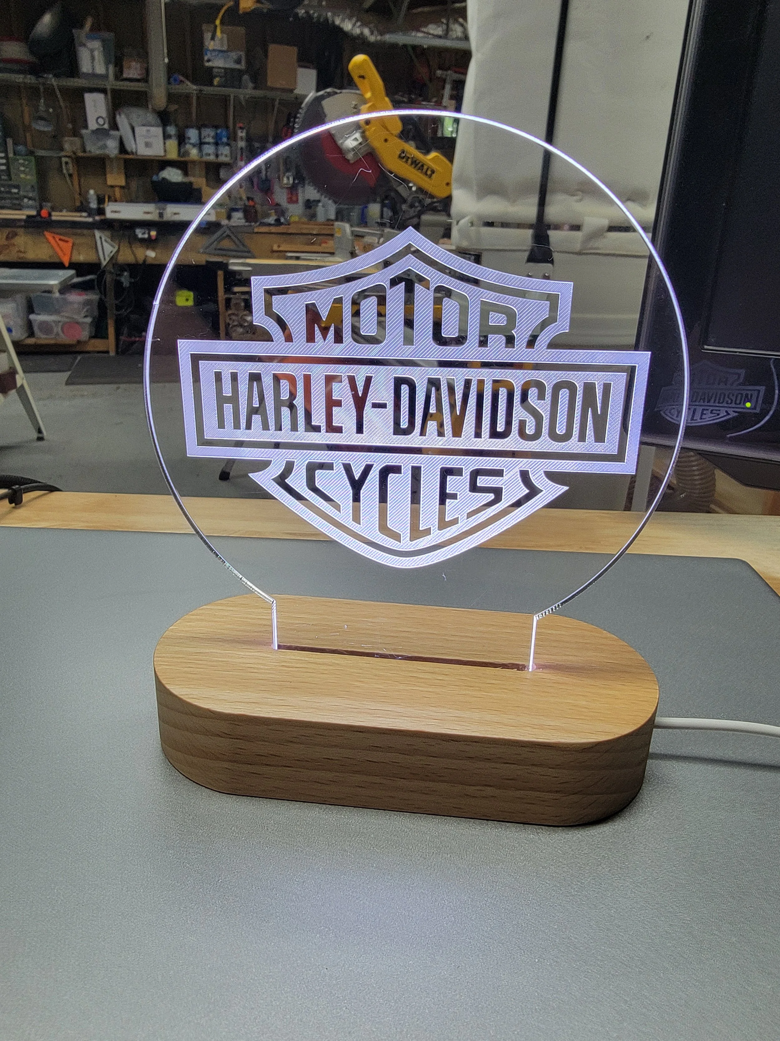 LED lamp with Harley-Davidson logo in a workshop setting.