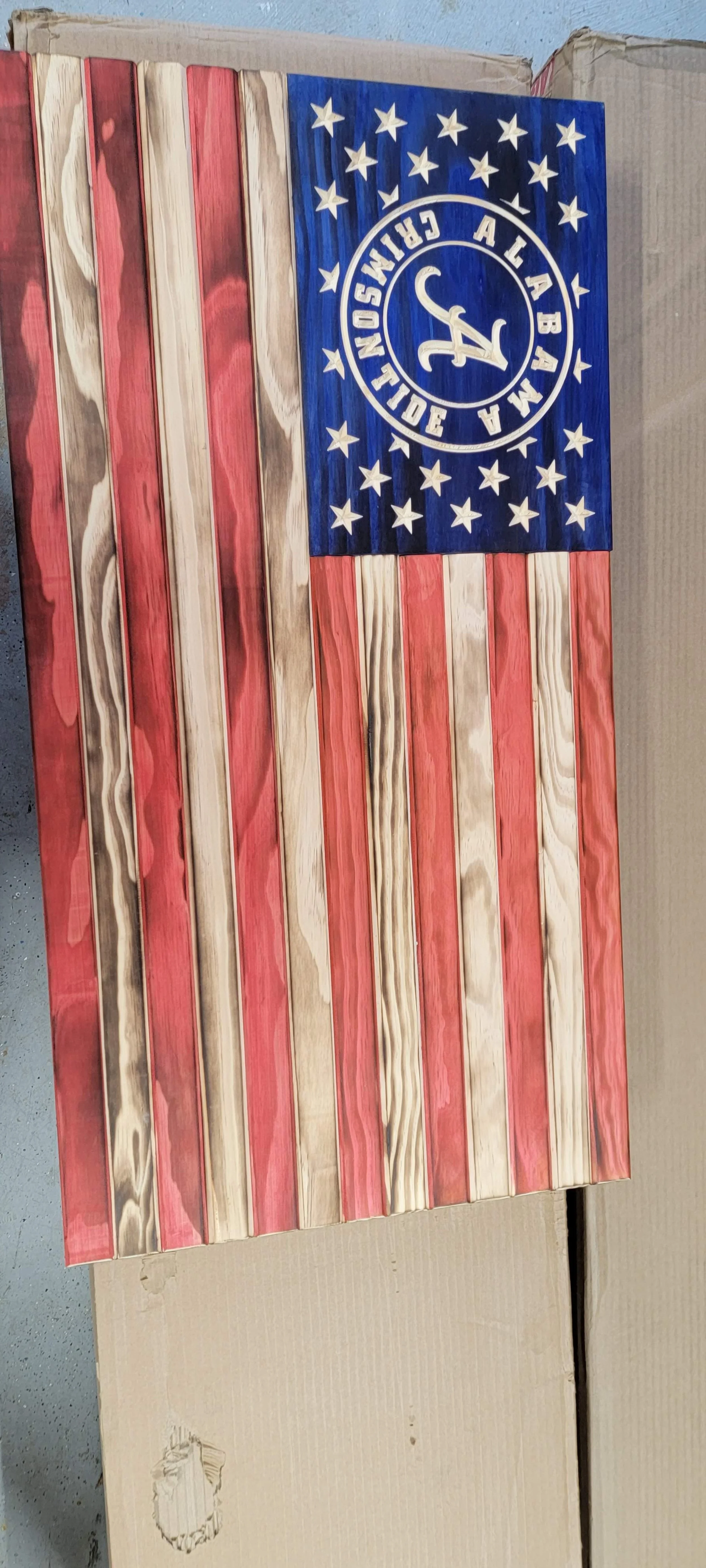 Wooden American flag with Alabama Crimson Tide logo in blue star field.