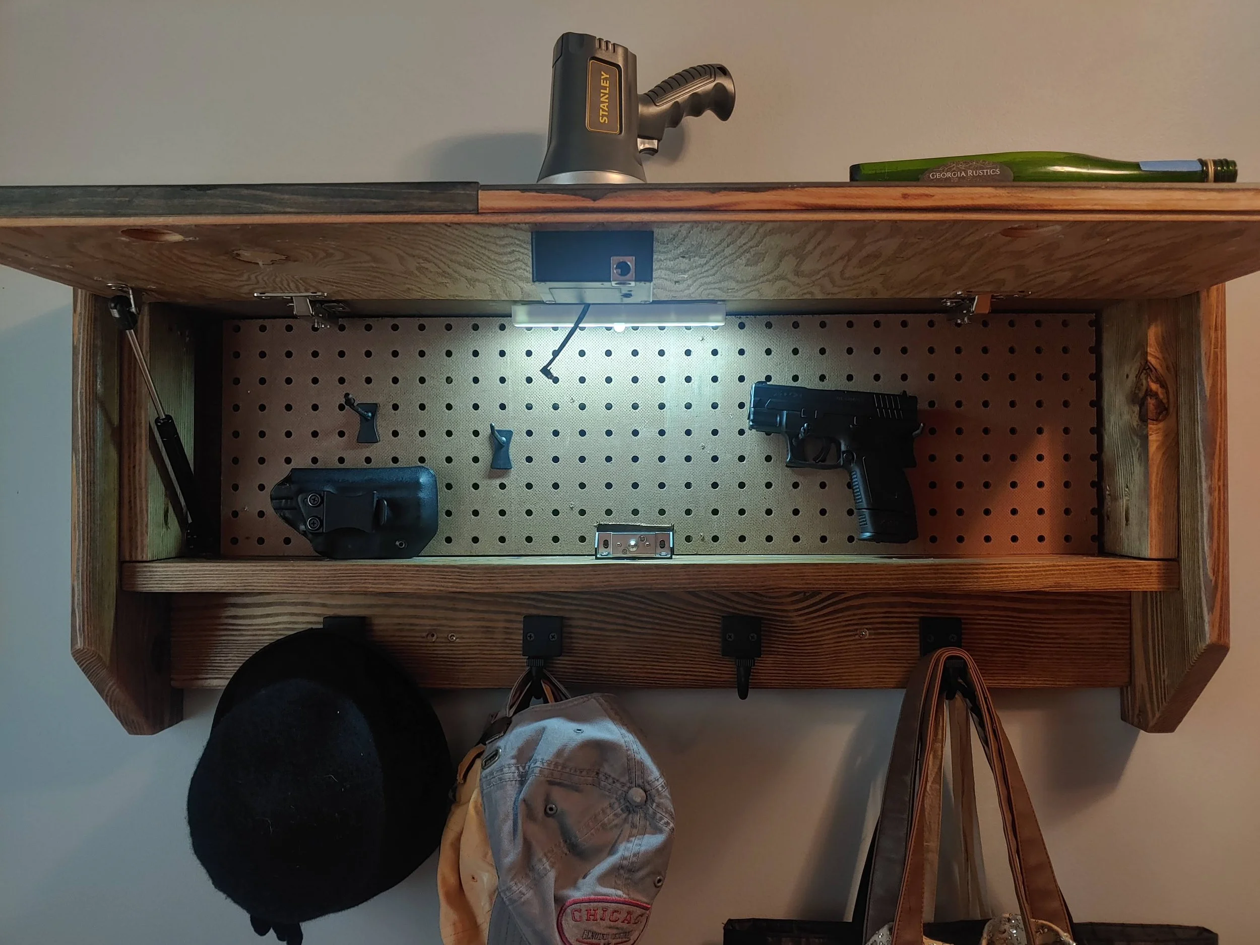 Hidden storage compartment with pegboard insert inside 250th Anniversary concealment coat rack
