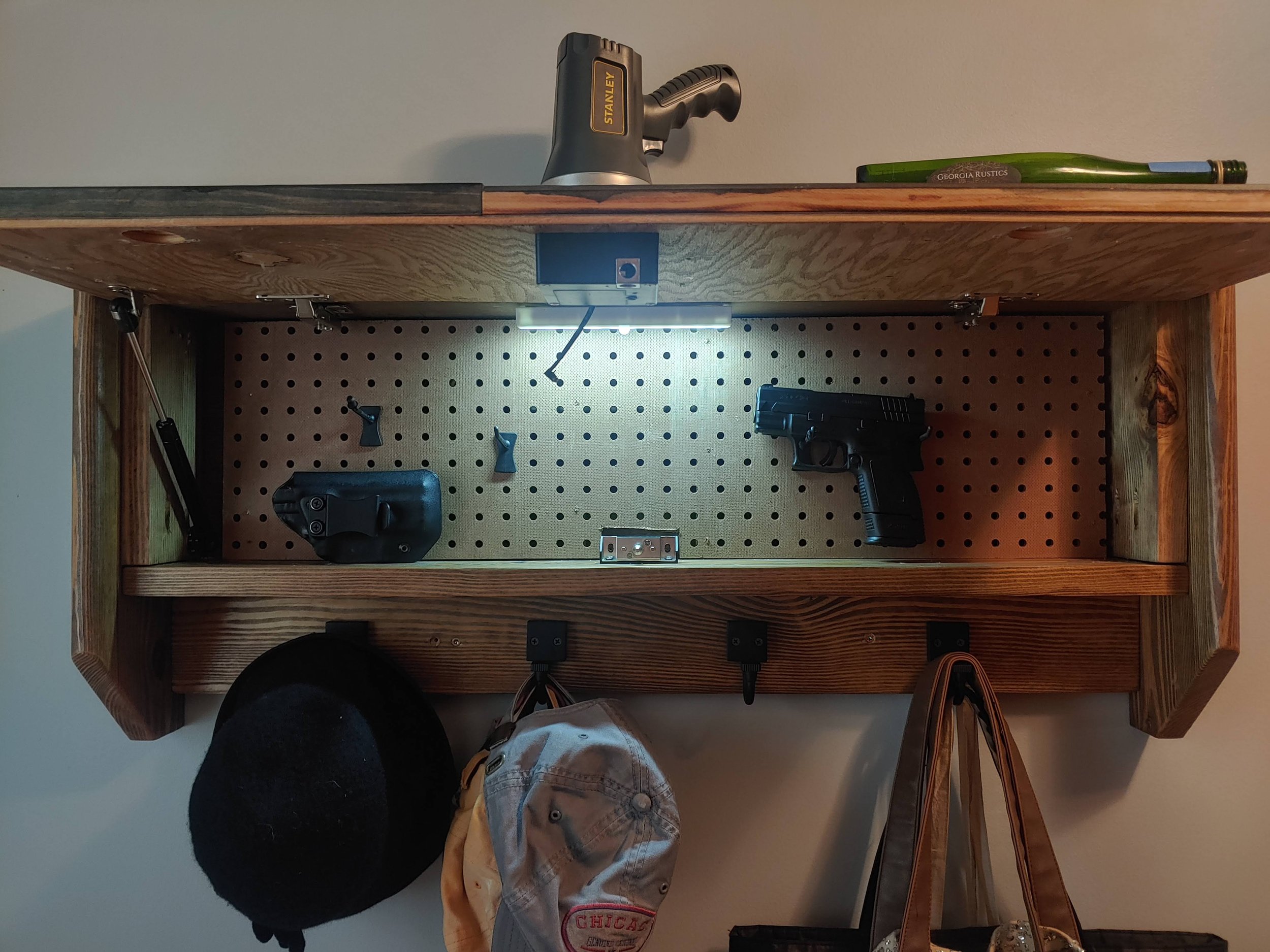 Military Branch Flag Concealment Coat Rack mounted on an entryway wall beside a door
