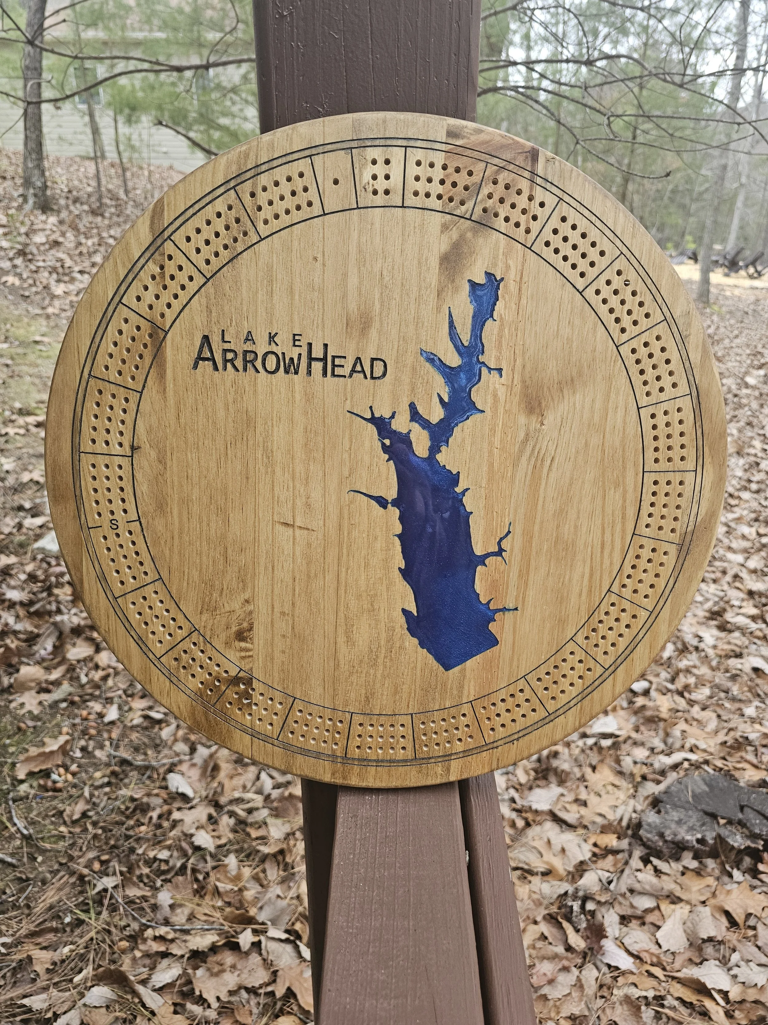 Circular wooden board with a cribbage track and "Lake Arrowhead" text and blue lake outline.
